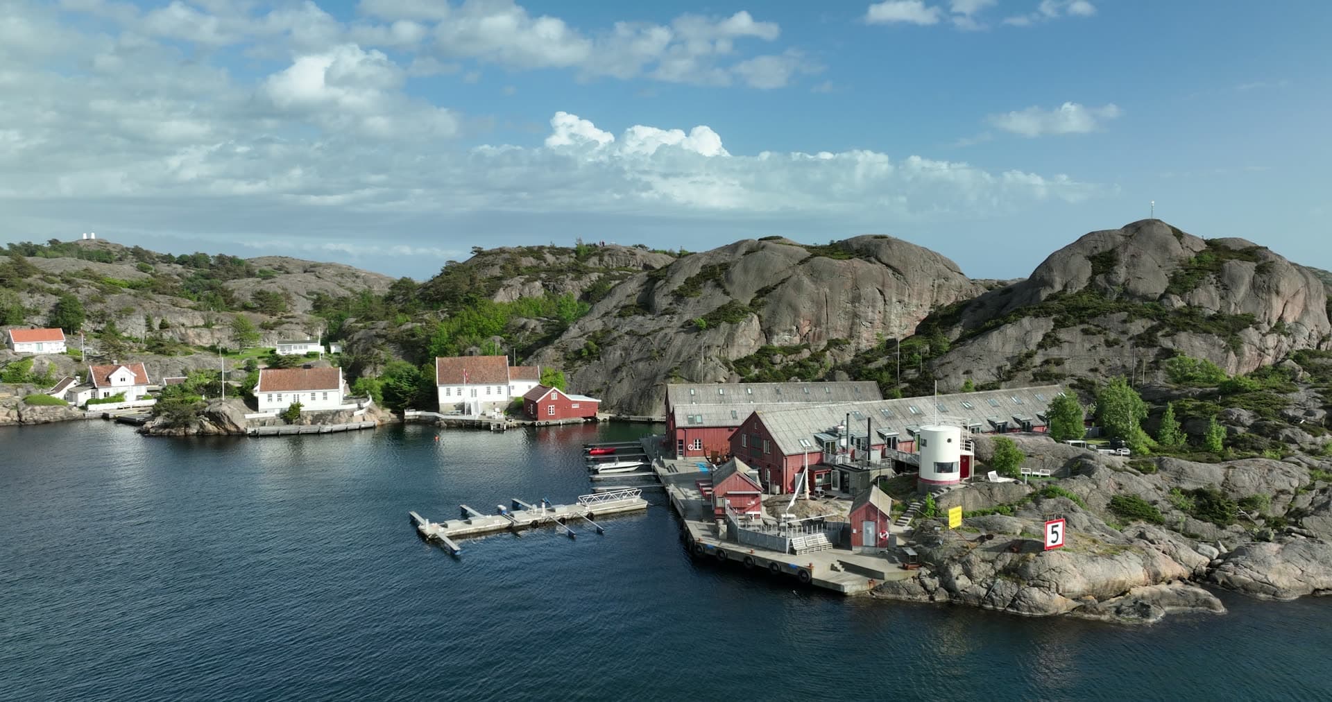Red wooden buildings and fair weather clouds, Ny-Hellesund