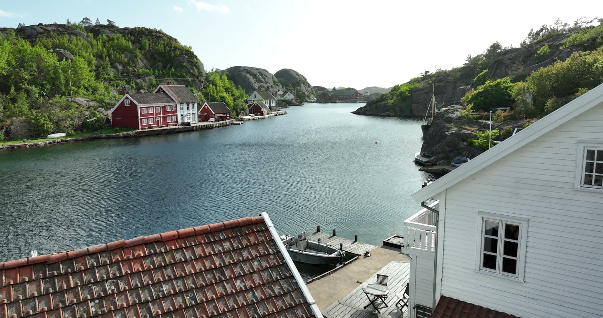 Red and white buildings and lush green vegetation, Ny-Hellesund