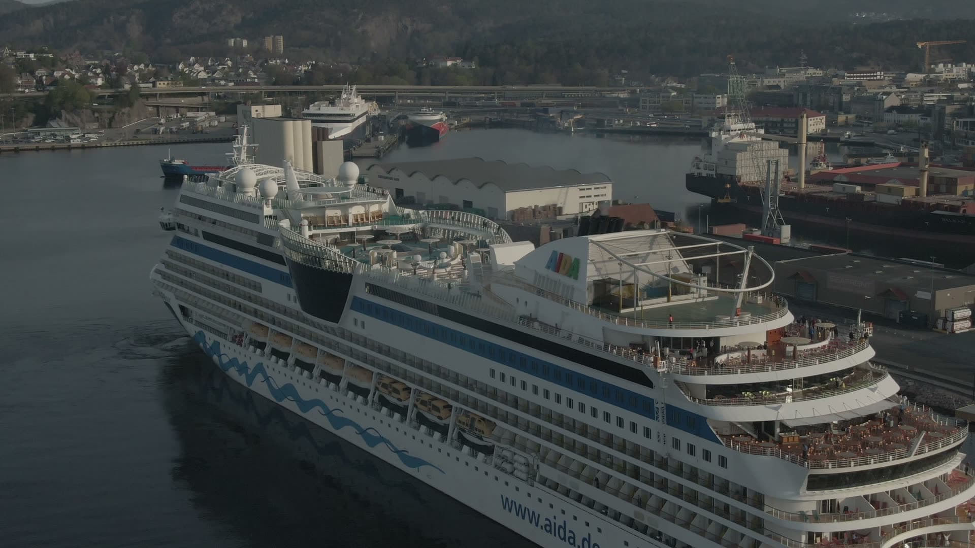 Early spring and white with cruise vessel entering the harbour, Kristiansand