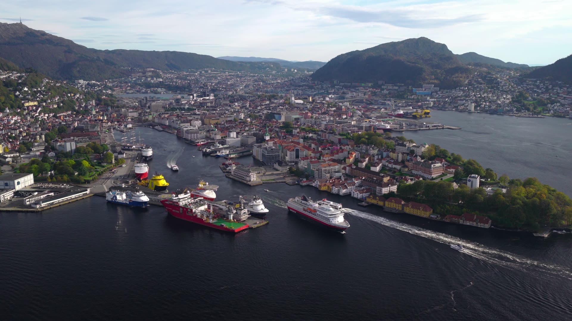 Large cruise ship departing narrow fjord waterway, Bryggen, Bergen, Norway