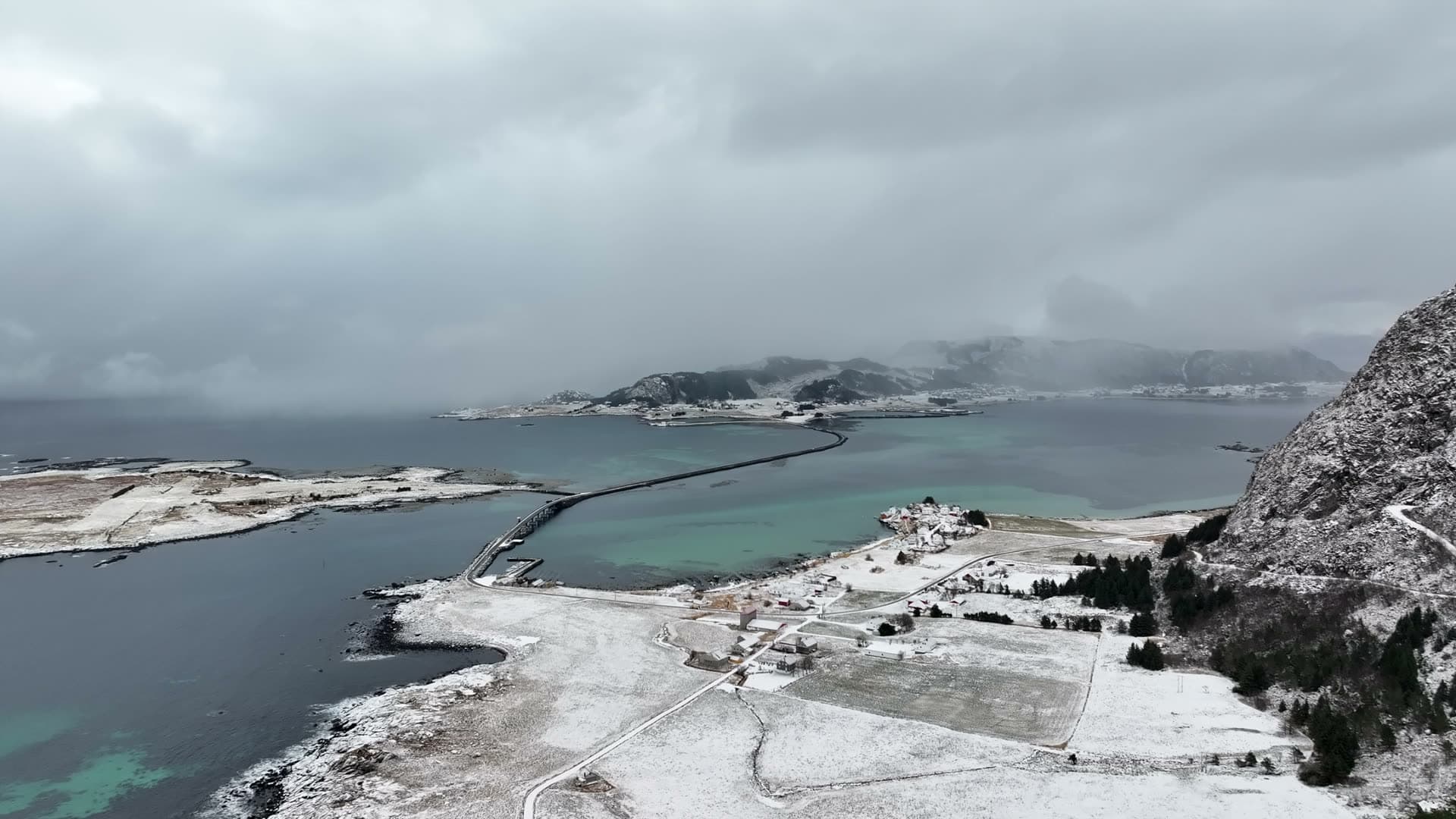 Snowy coast and low clouds near Ulla on Haramsøy