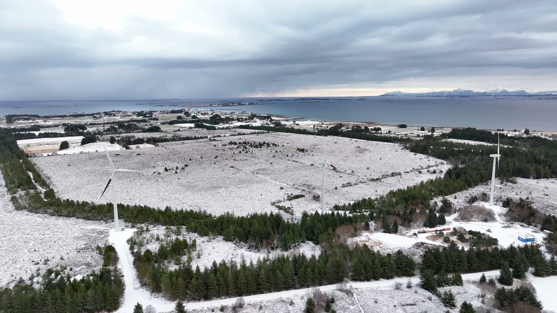 Wide aerial view of a coastal wind farm in winter, Harøy