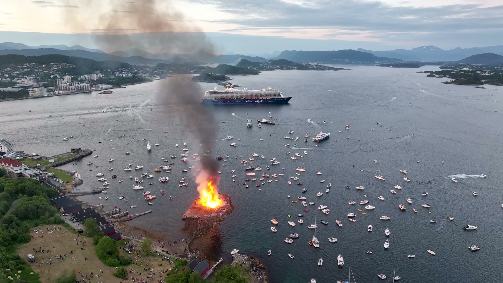 Slinningsbålet bonfire and boats on the waterfront in Ålesund