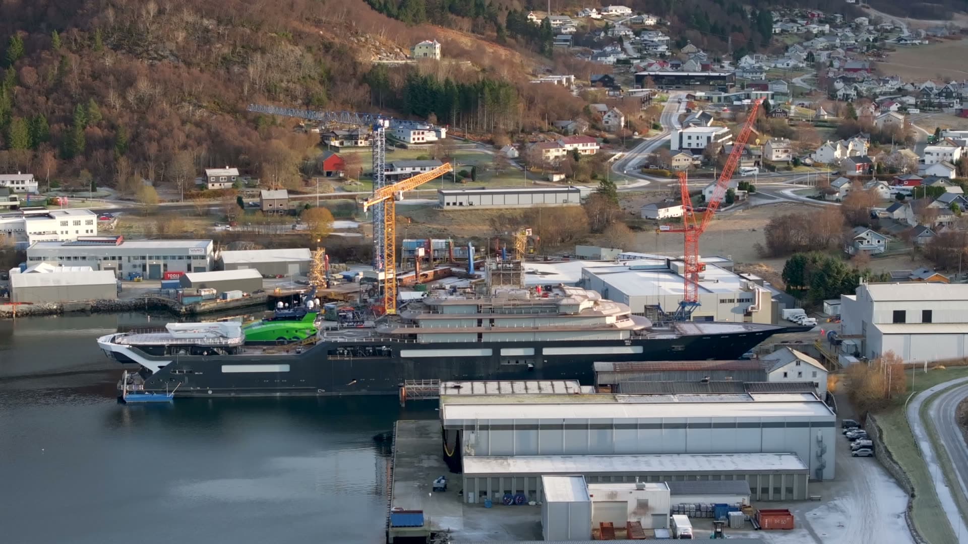 Rising side view of REV Ocean and the surrounding shipyard