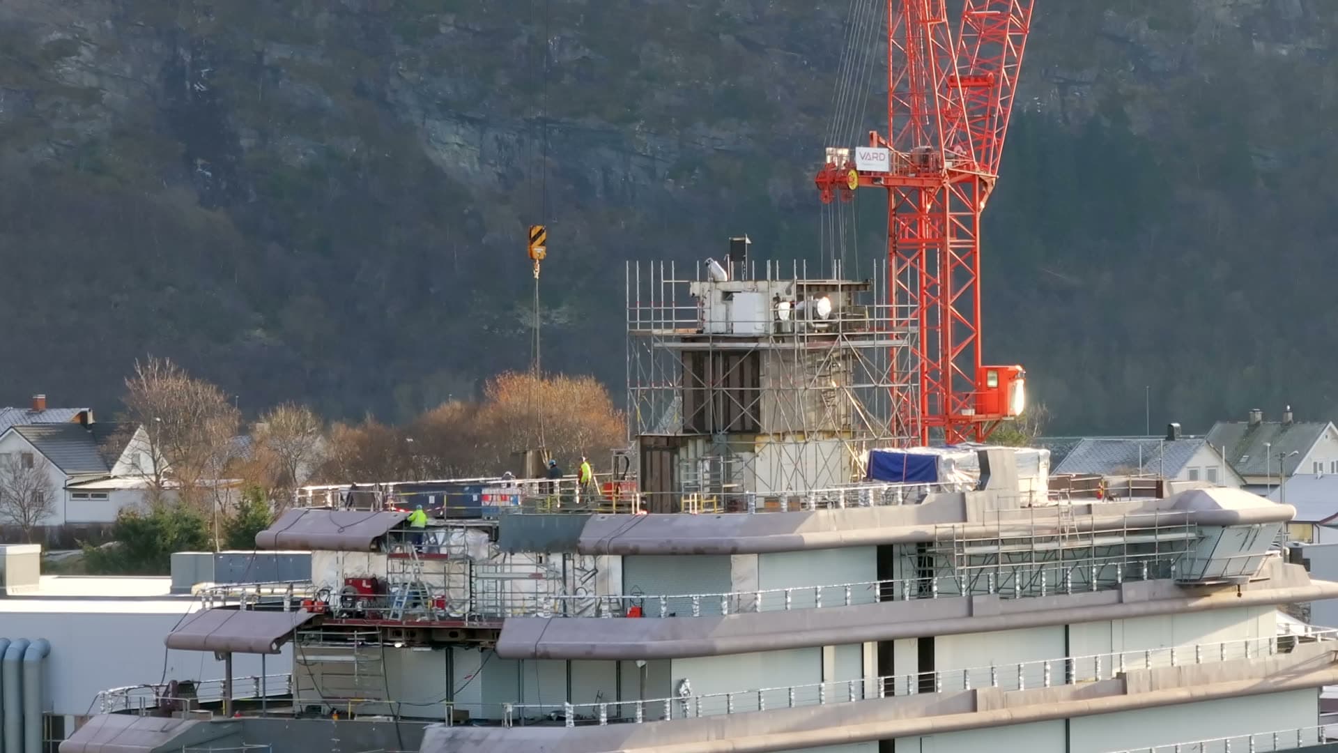 Close side view of REV Ocean superstructure and a red crane