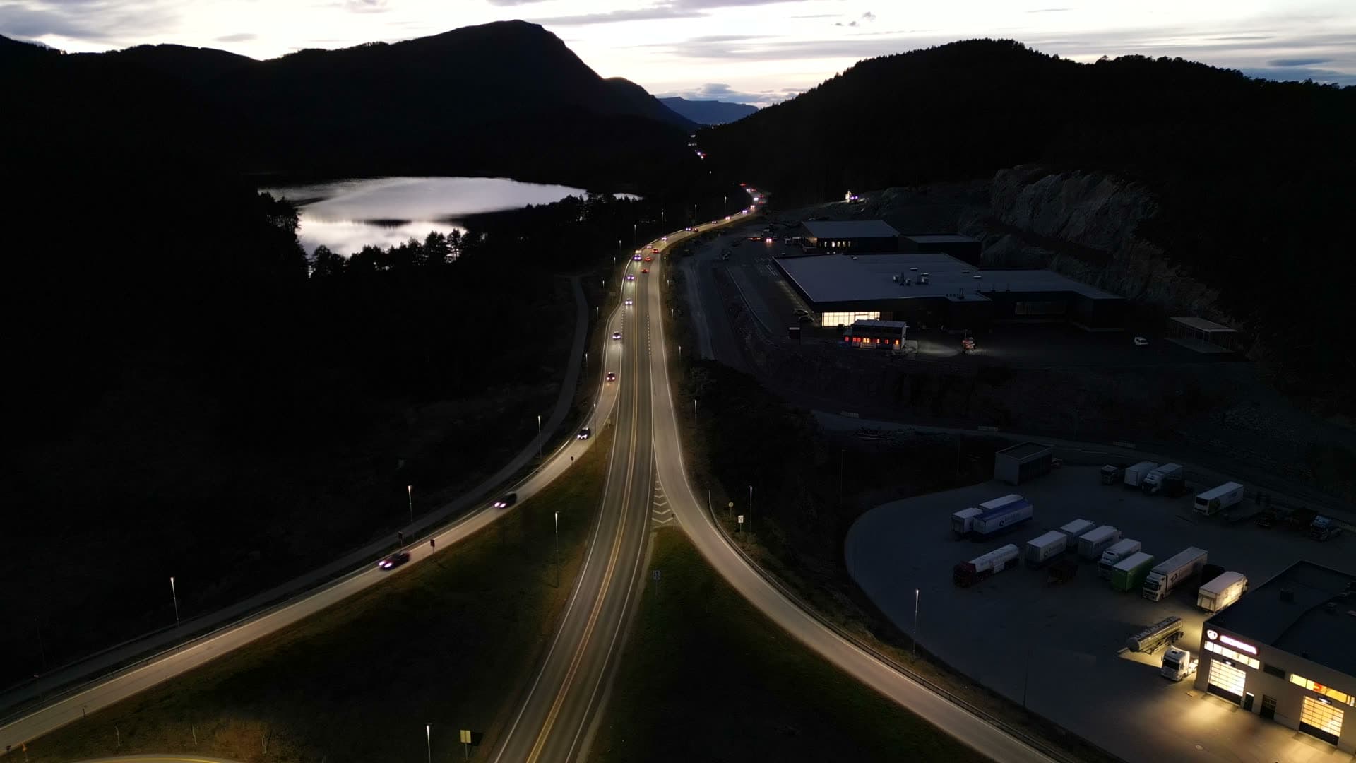 Road through wooded hills beside Digernes at twilight