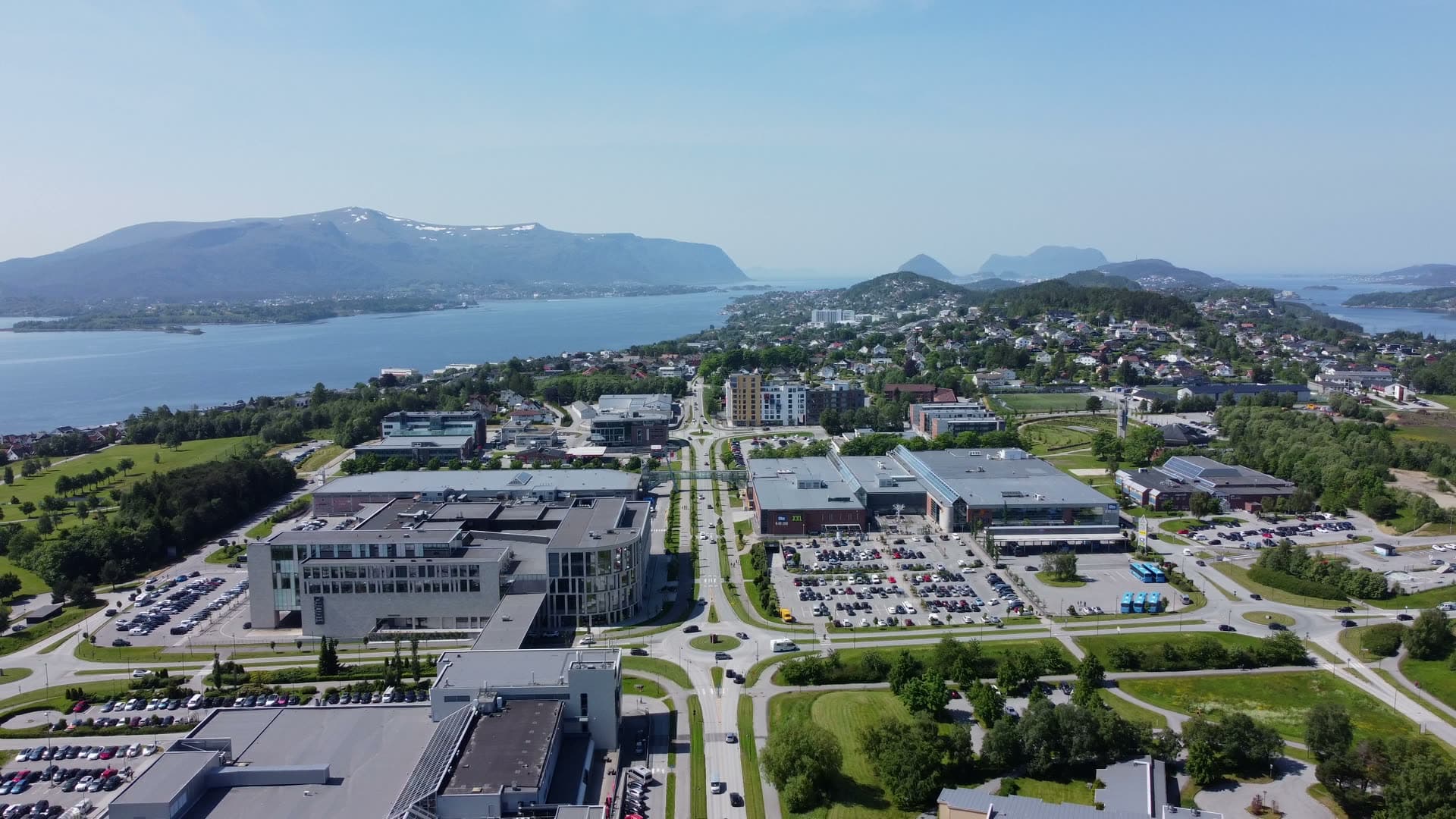 Drone view over Moa roads and retail buildings toward the fjord