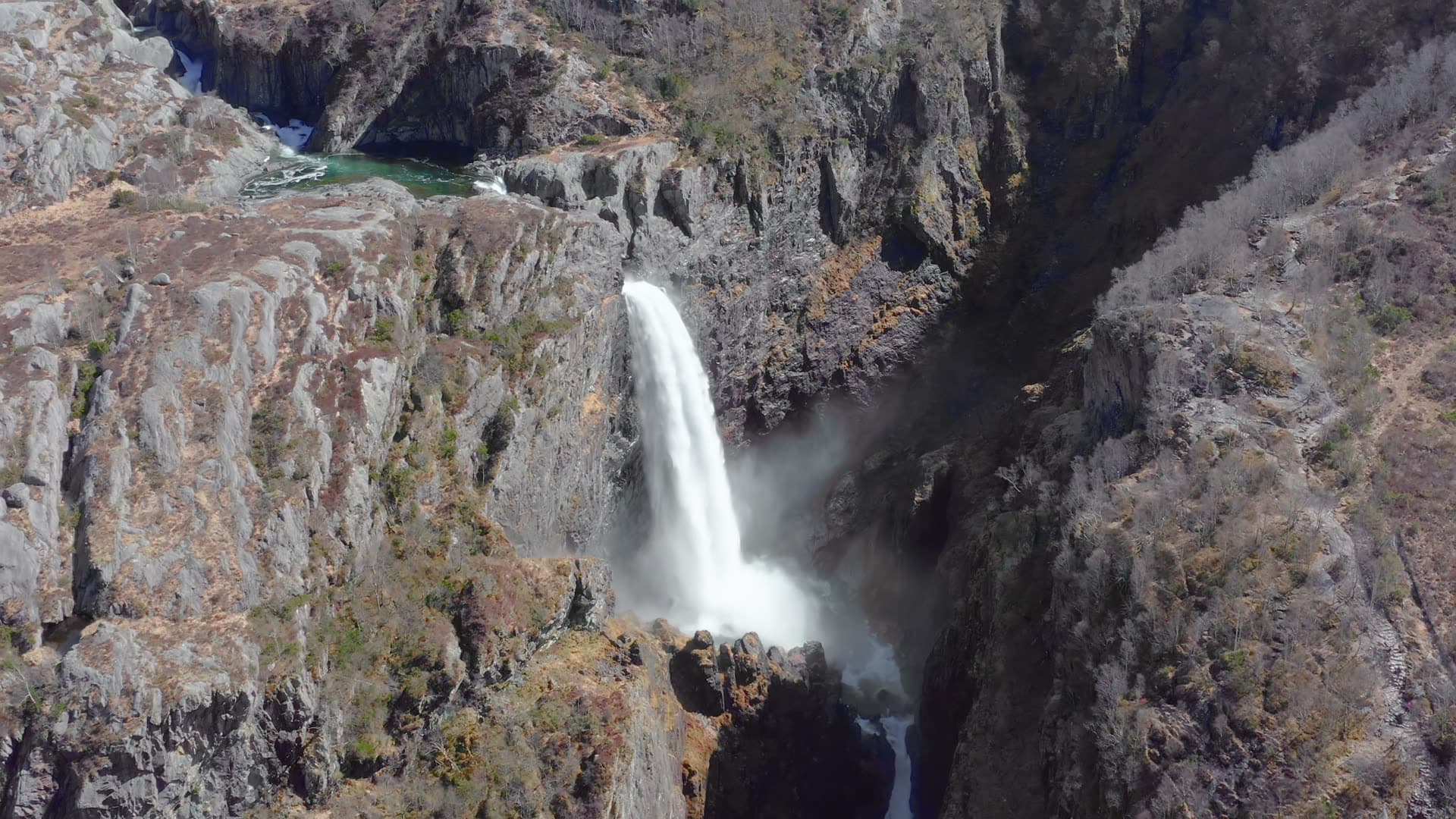 Waterfall in narrow rocky canyon, Månafossen