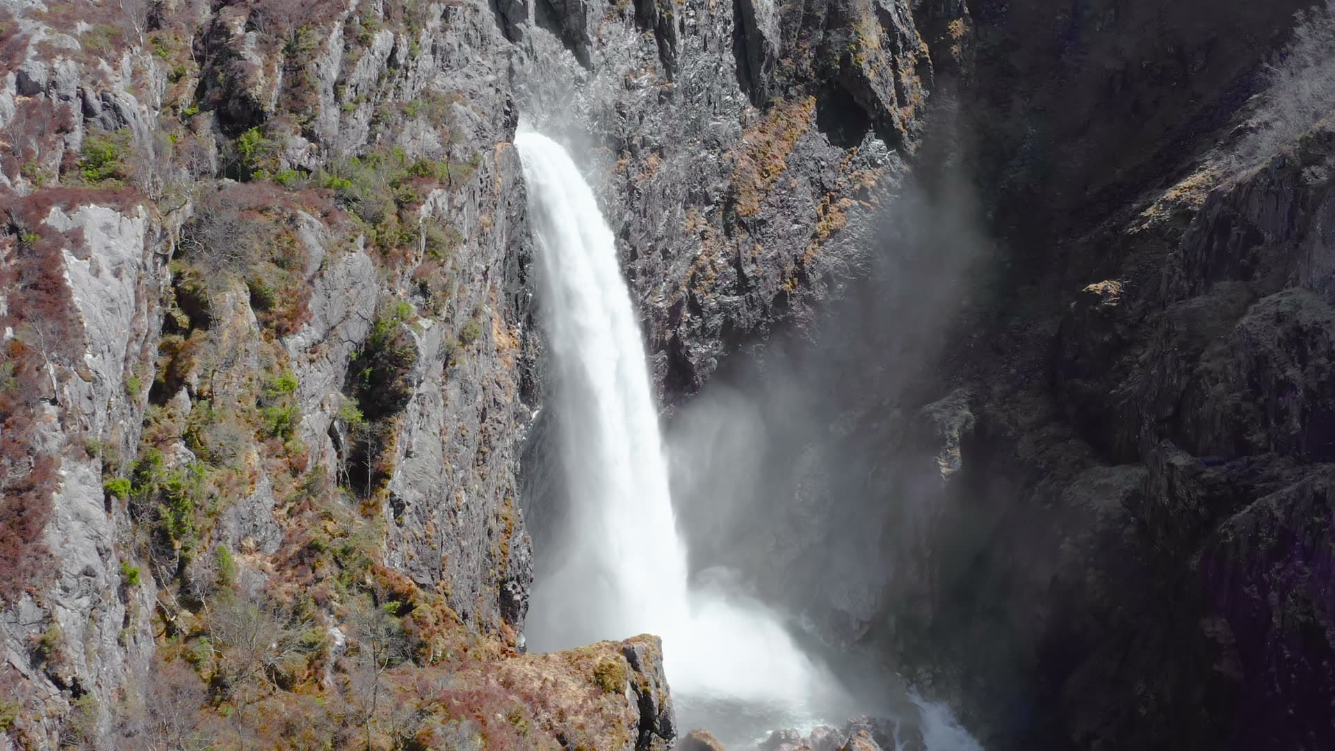 Waterfall cascading through narrow rocky canyon, Månafossen