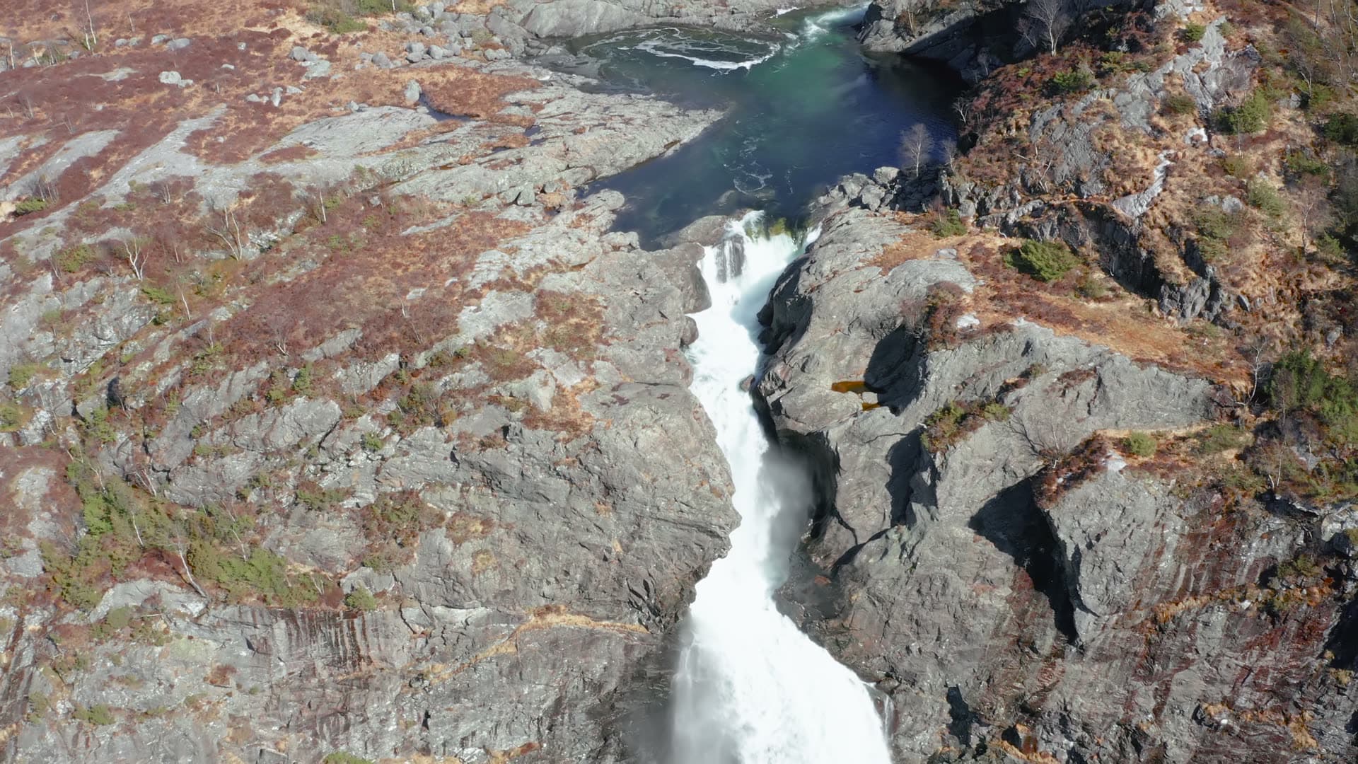 Mountain waterfall through rocky gorge, Månafossen