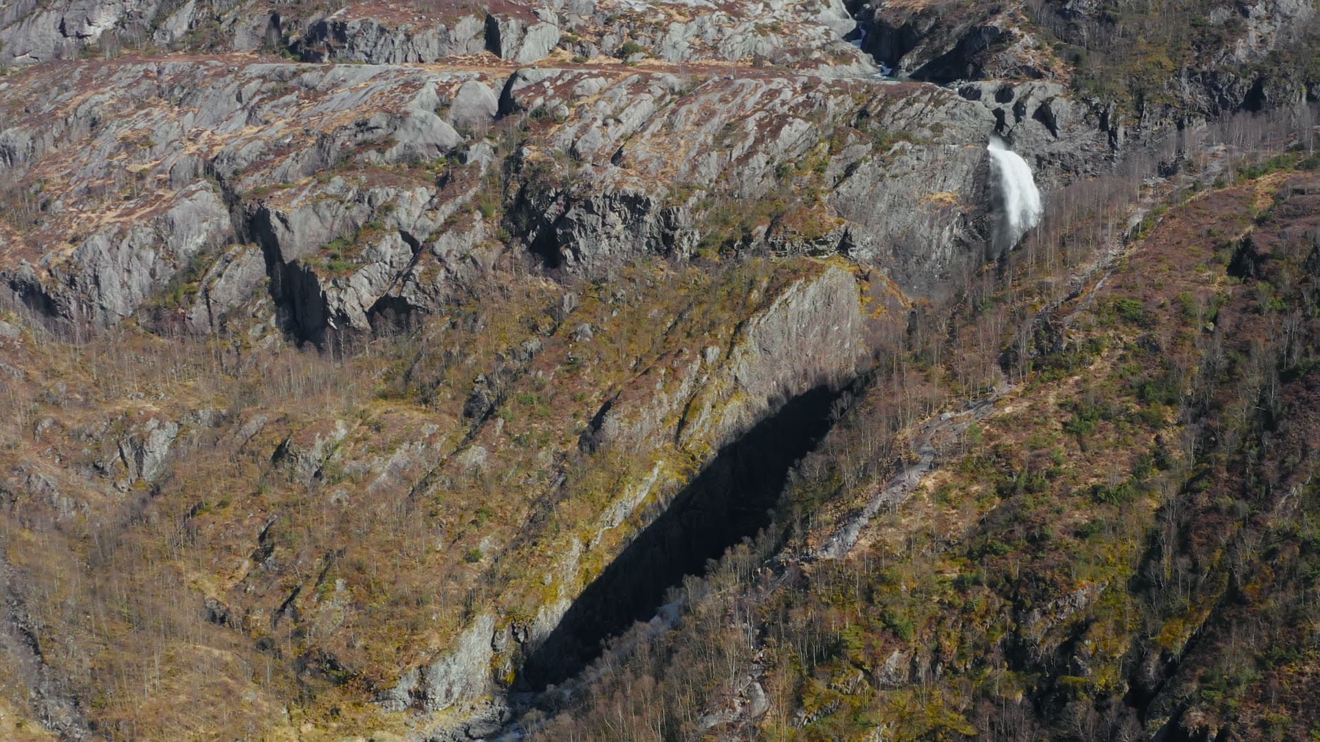 Mountain waterfall in rocky gorge, Månafossen