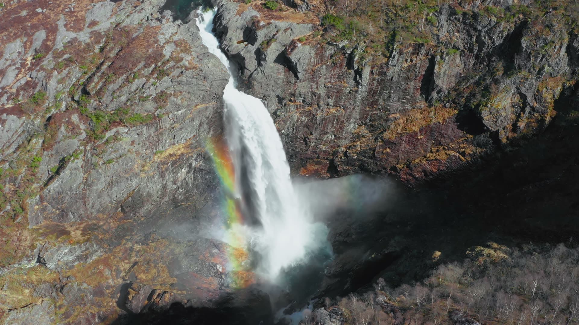 Waterfall cascading into turquoise pool, Månafossen