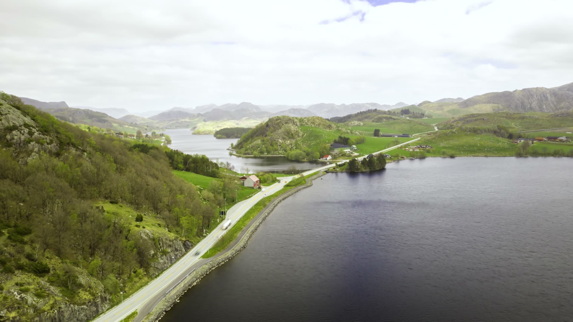 Mountain lake with shoreline road and valley settlement, Ålgård