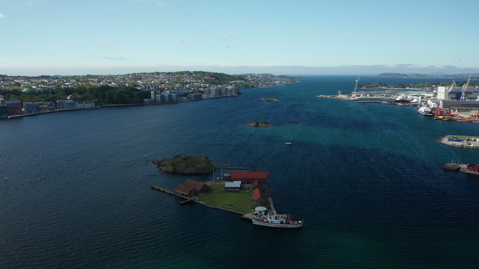 Red cargo ship in working harbor, Stavanger