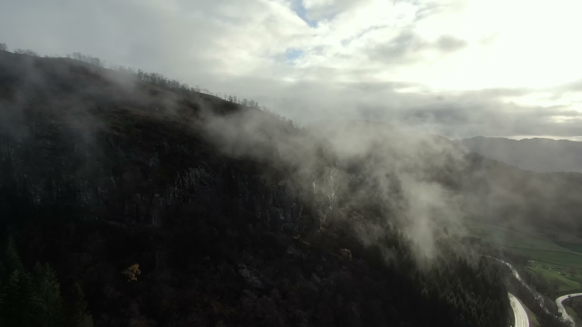 Winding valley road through misty mountains, Ingvaldstad