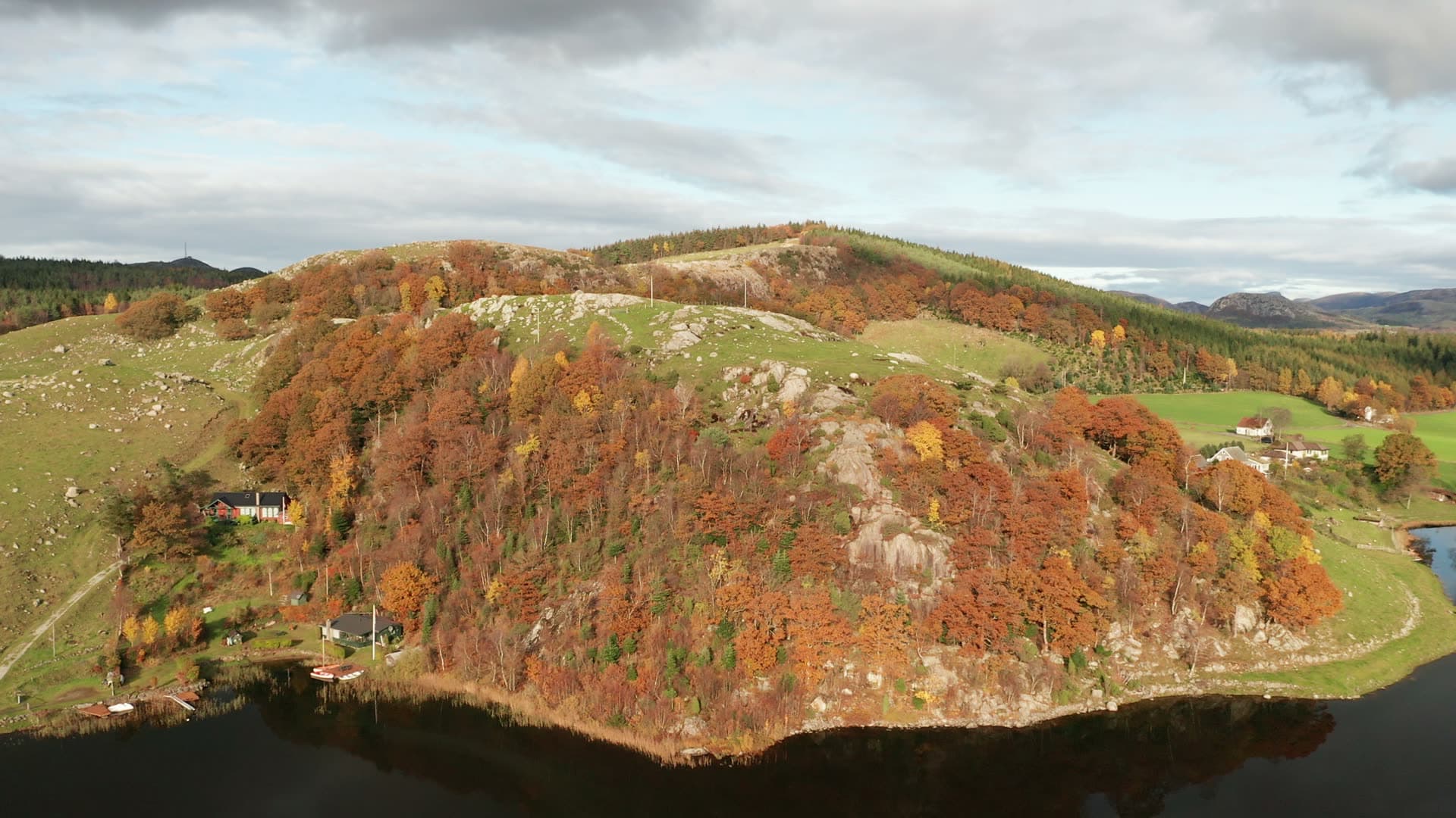 Forested hillside above rural lake, Bråsteinvatnet