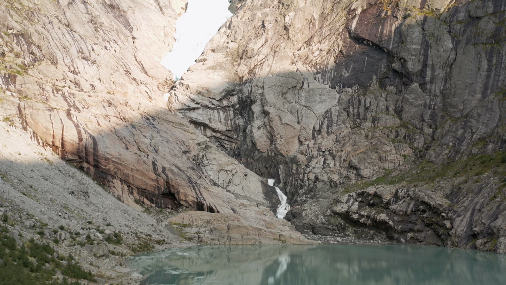 Glacier lake in rocky mountain valley, Briksdalsbreen