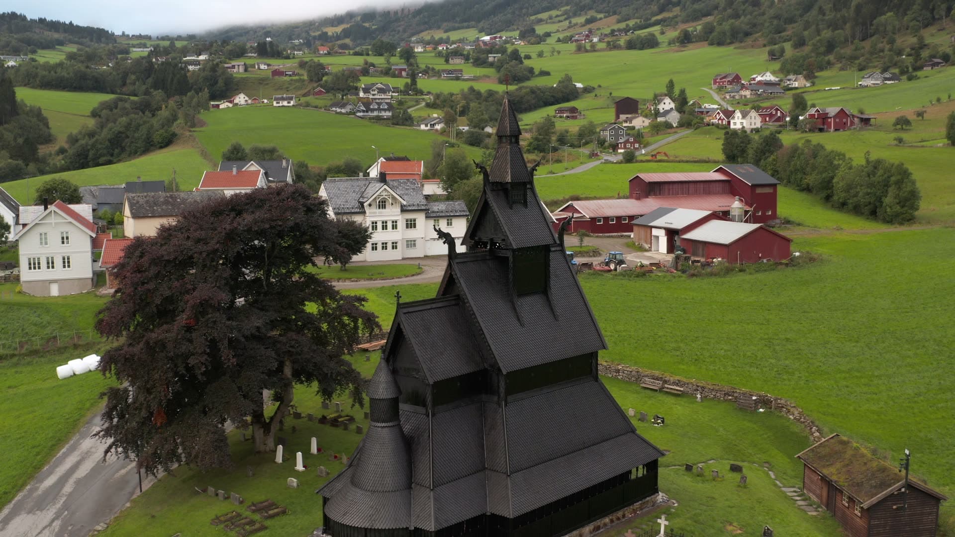 Black wooden stave church in rural valley, Hopperstad stavkirke