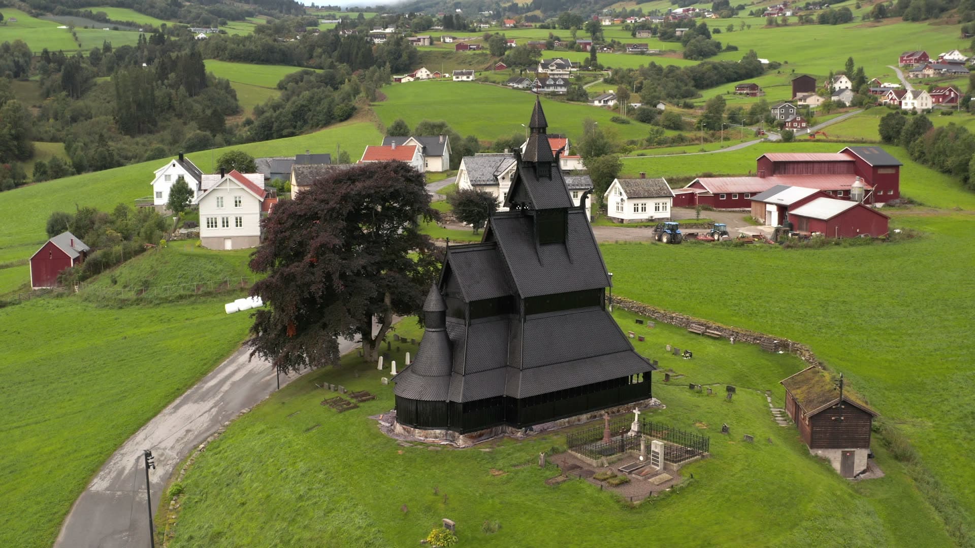 Black stave church in green valley, Hopperstad stavkirke
