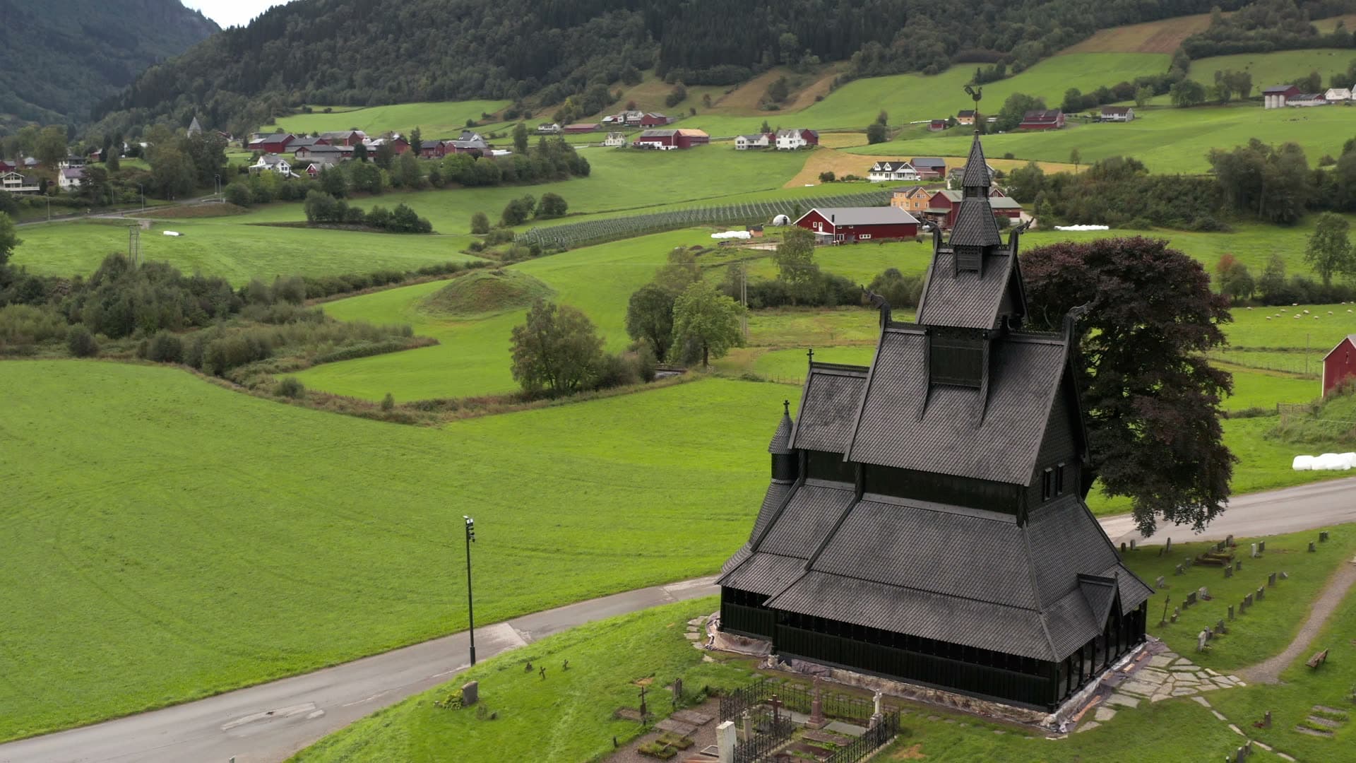 Black wooden stave church in mountain valley, Hopperstad stavkirke