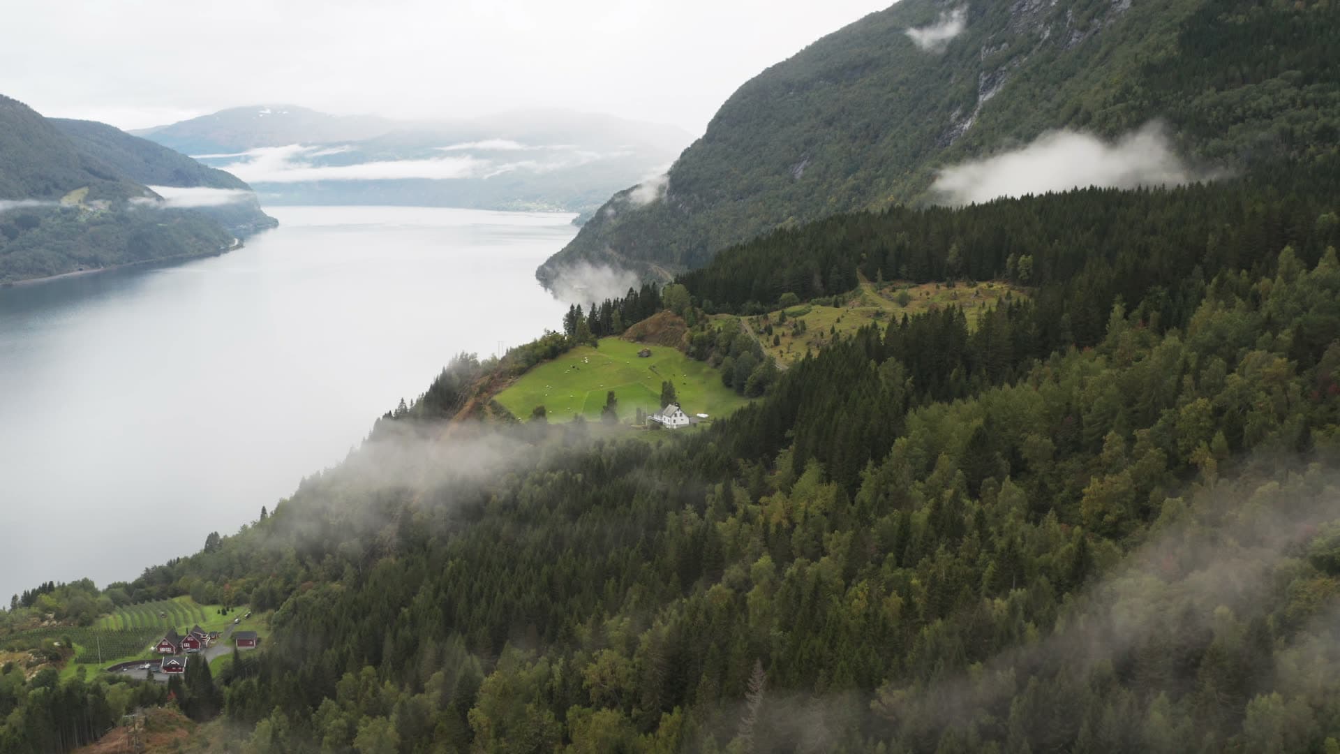Remote house in misty fjord valley, Innvikfjorden