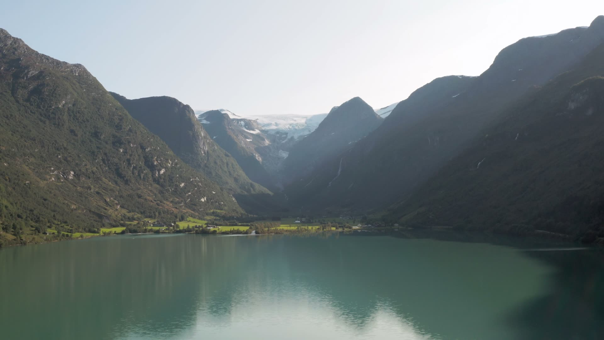 Turquoise alpine lake between mountain peaks, Oldevatnet
