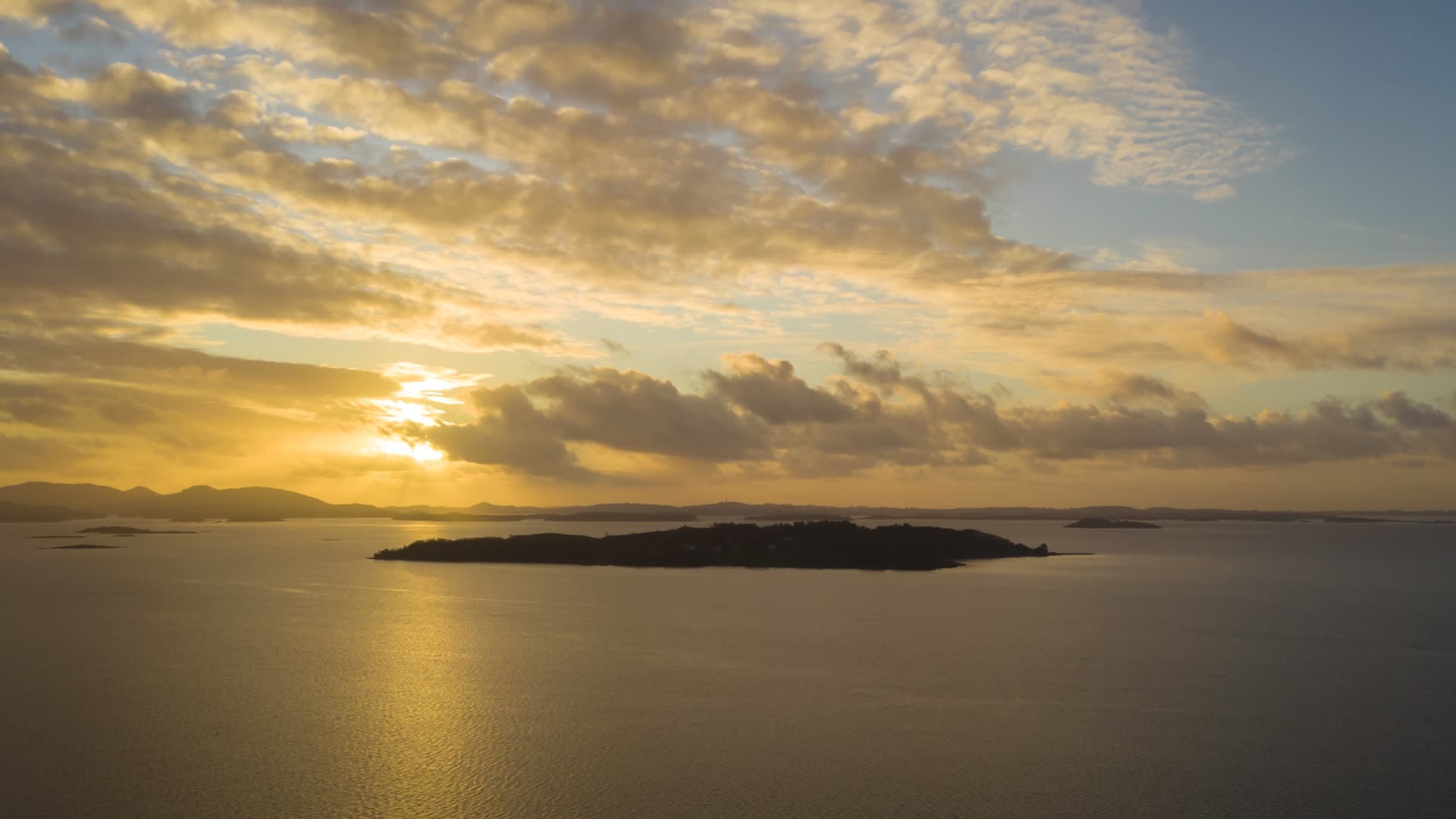 Island at sunset with golden sky reflection, Hetlandsvatnet