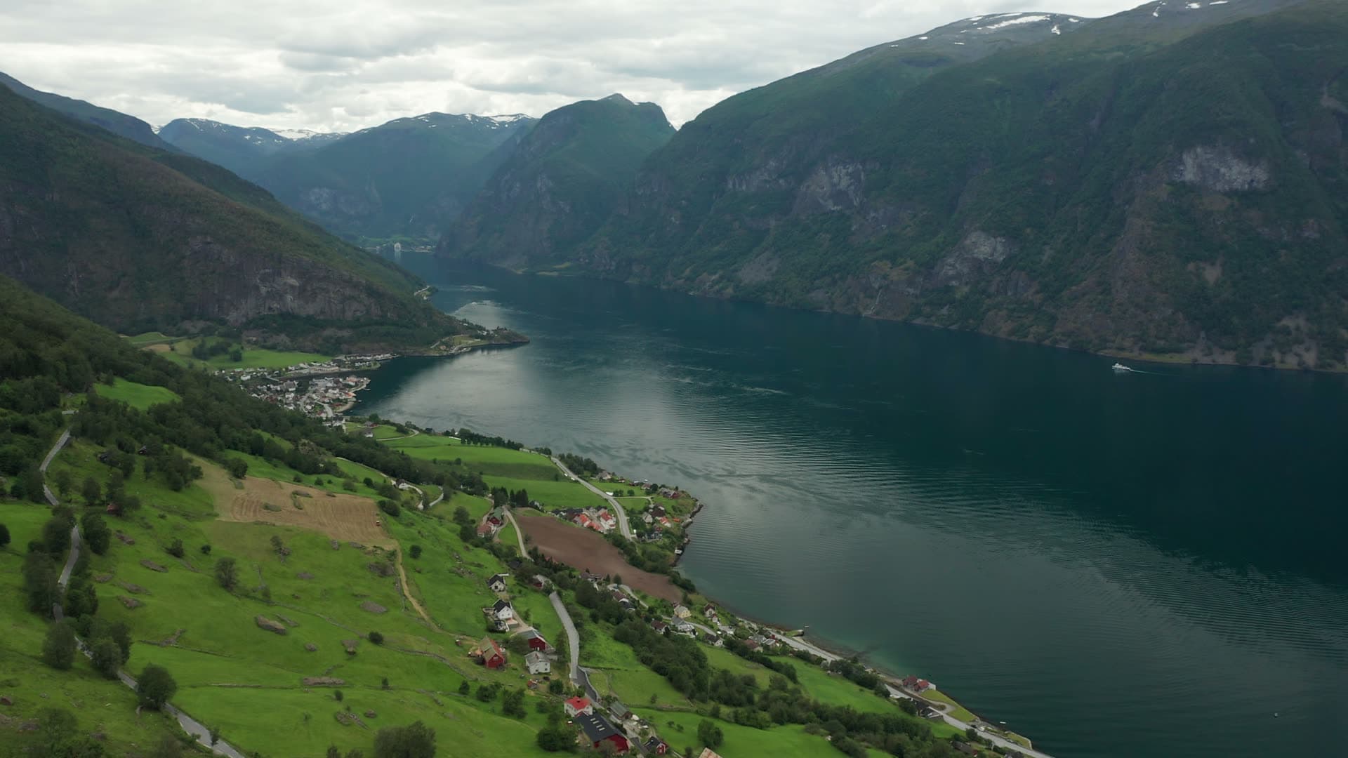 Alpine fjord valley with lakeside village, Flåm
