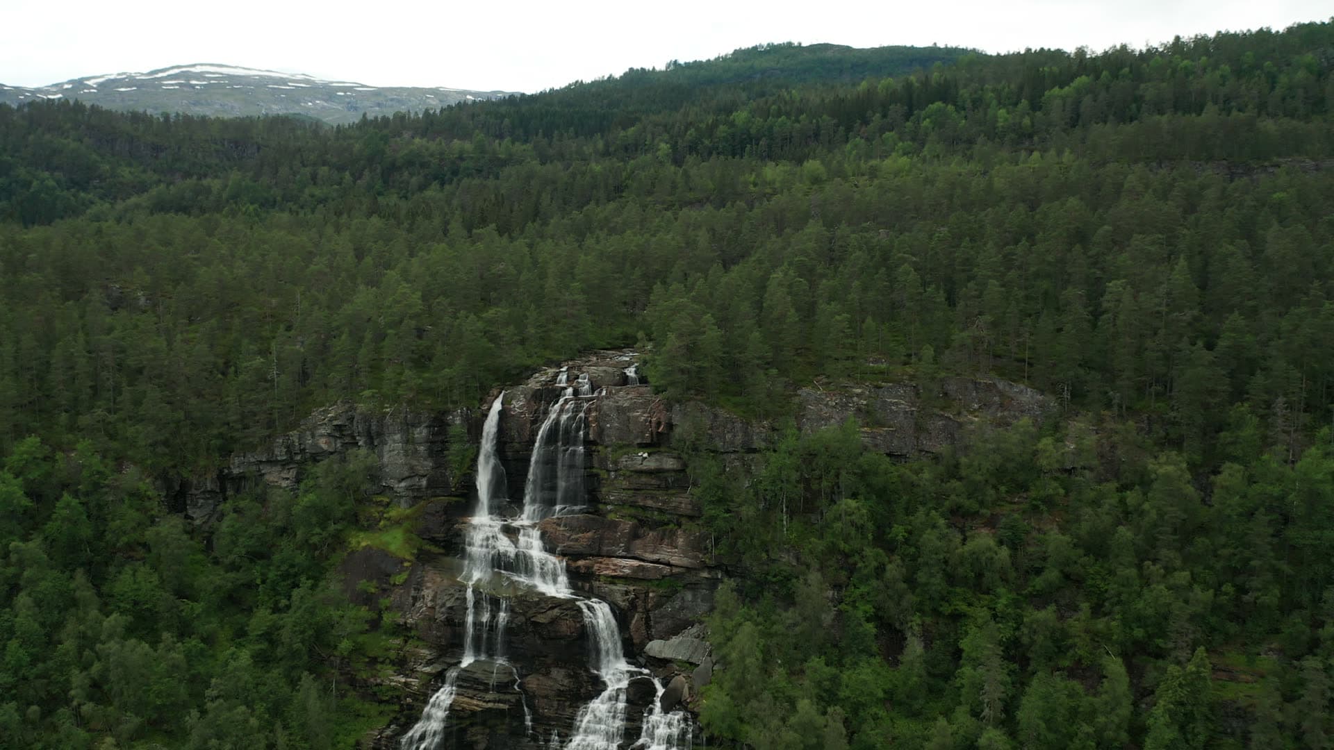 Multi-tiered waterfall in coniferous forest, Trollafossen