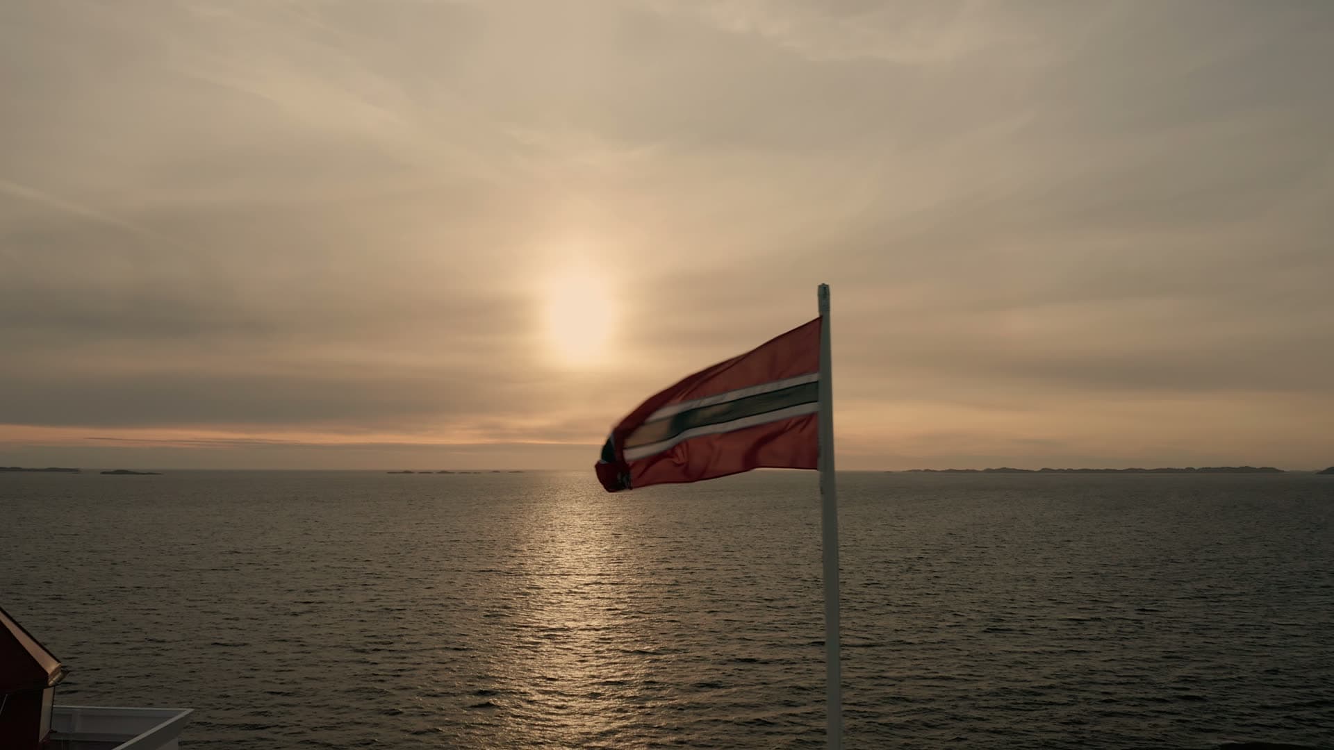 Norwegian flag at sea sunset, Ryvarden fyr