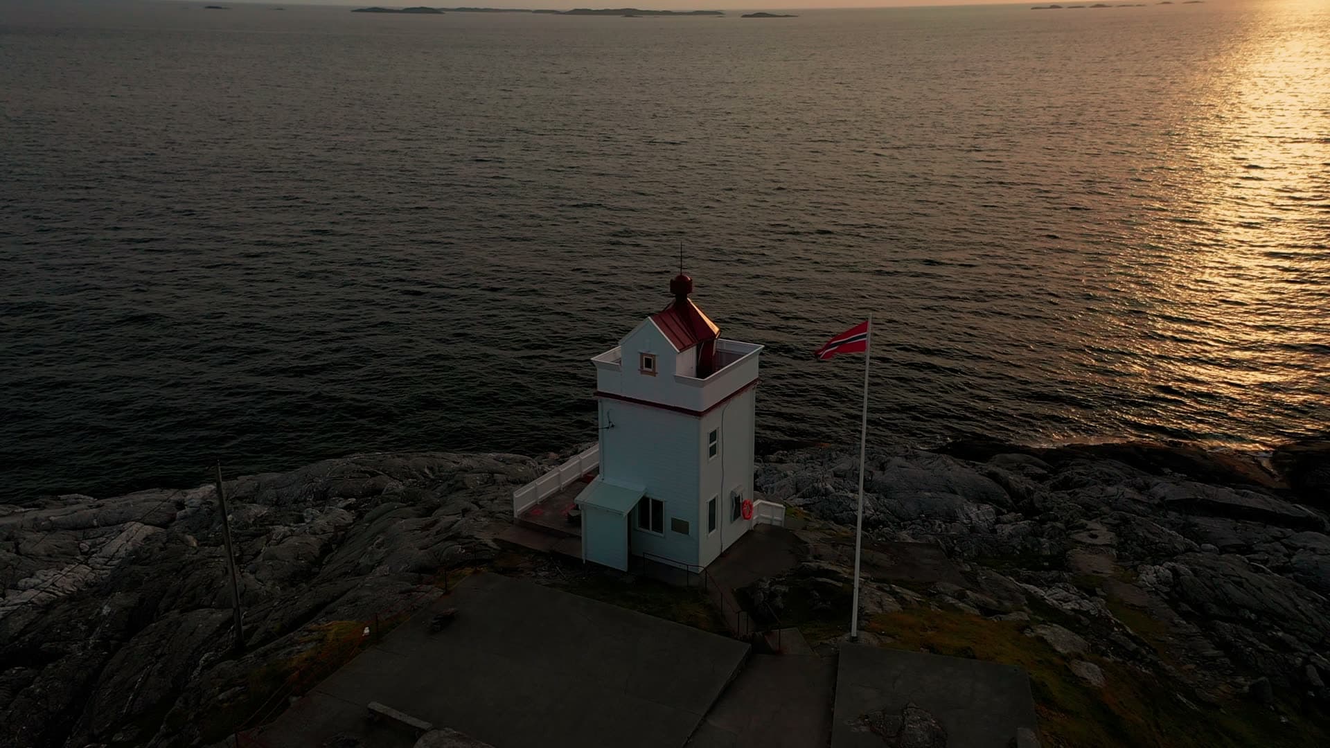 White lighthouse with red roof at sunset, Ryvarden fyr