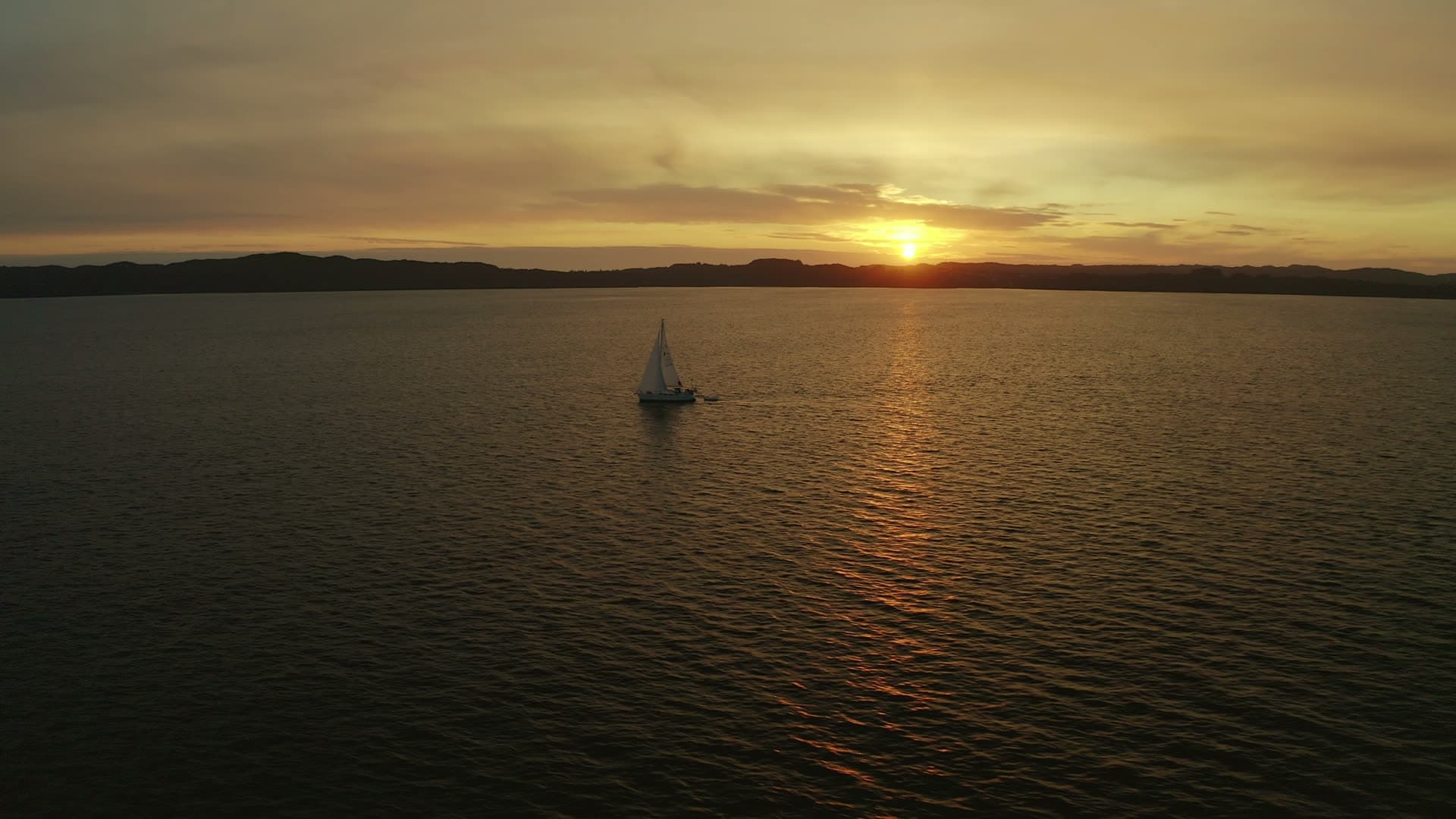 Sailboat at sunset on calm water, Sveio