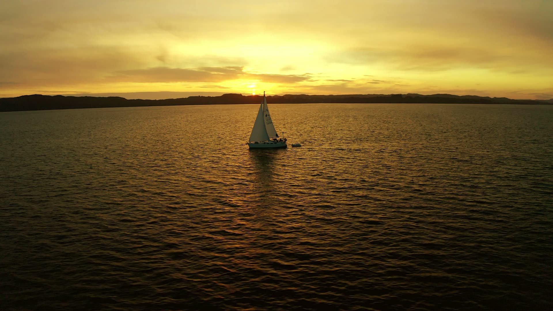 Sailboat at sunset in calm bay, Sveio