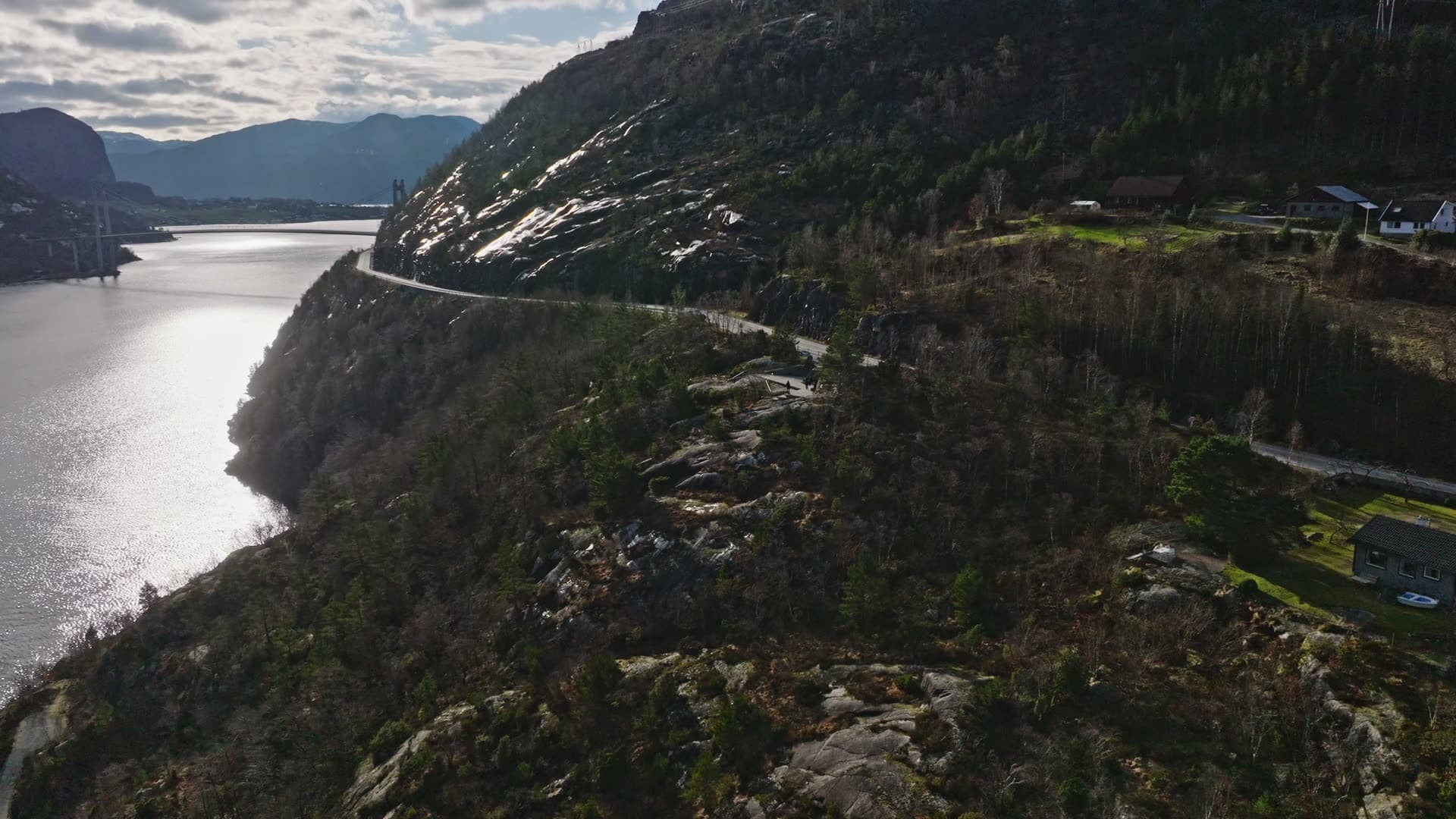Hikers on cliff overlooking fjord, Pulpit Rock