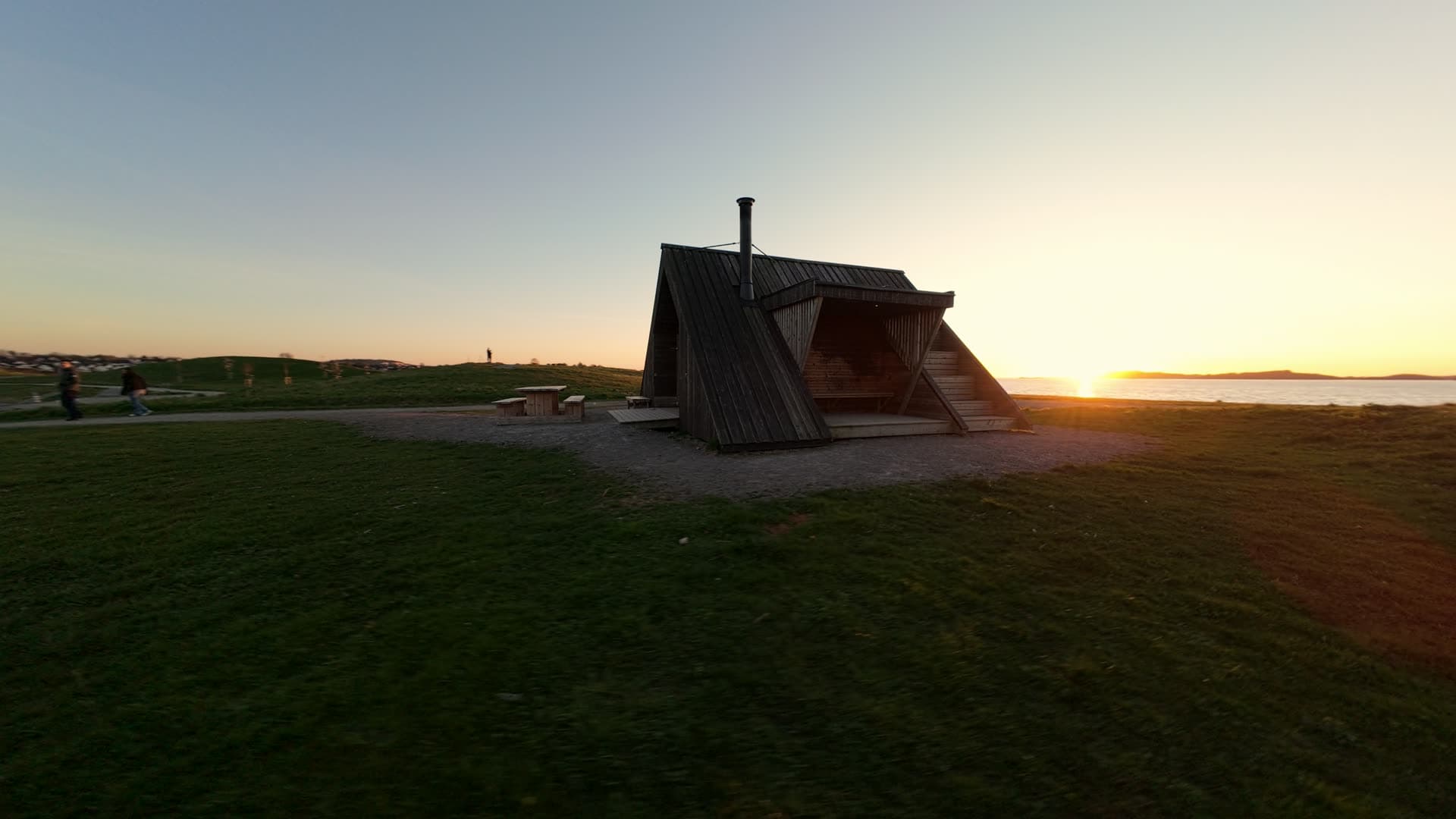 Stone dike and waterfront cottage at sunset, Stavanger, Hundvåg dagturshytta