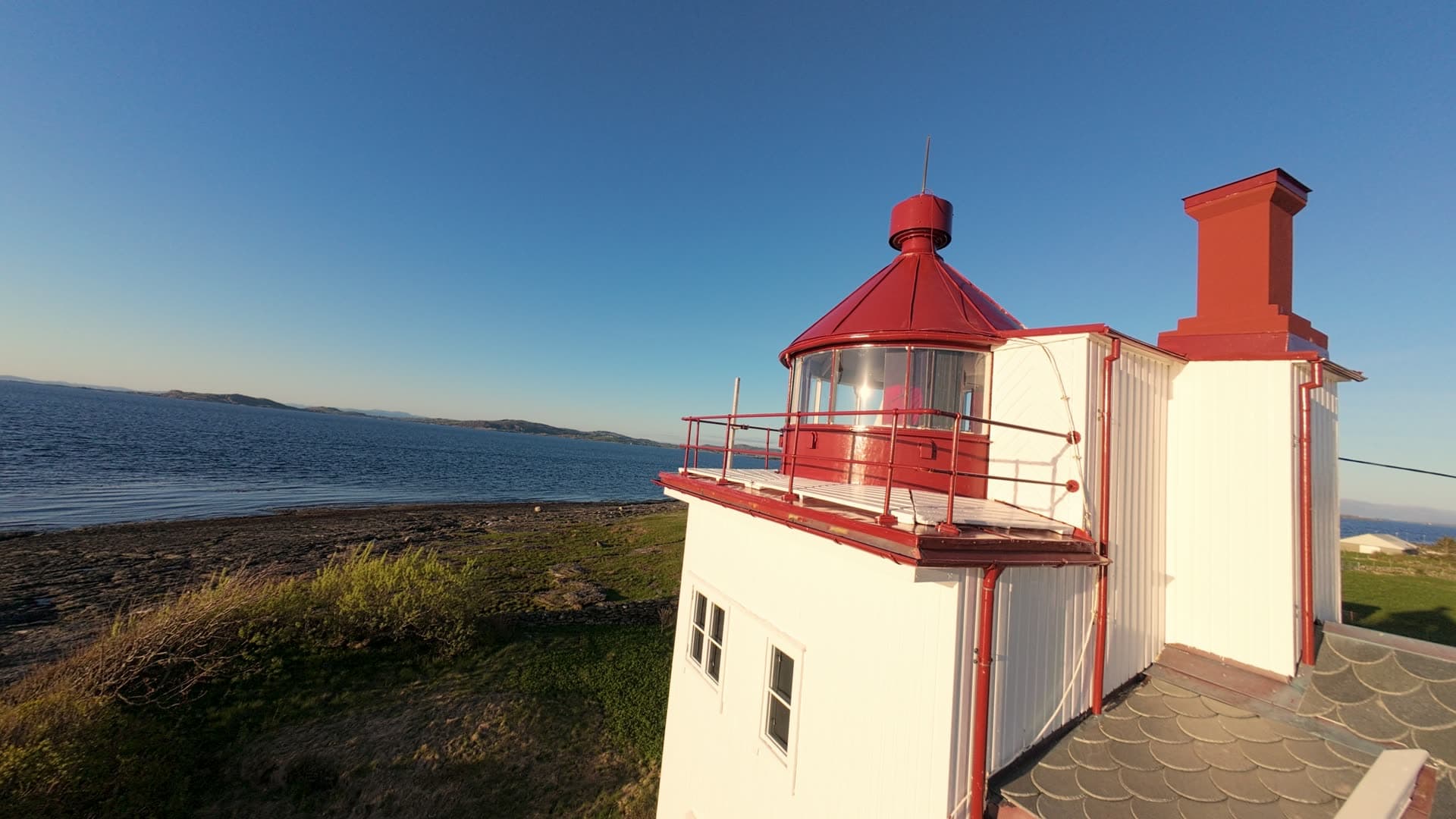 Lighthouse and coastal settlement on moorland, Tungenes fyr