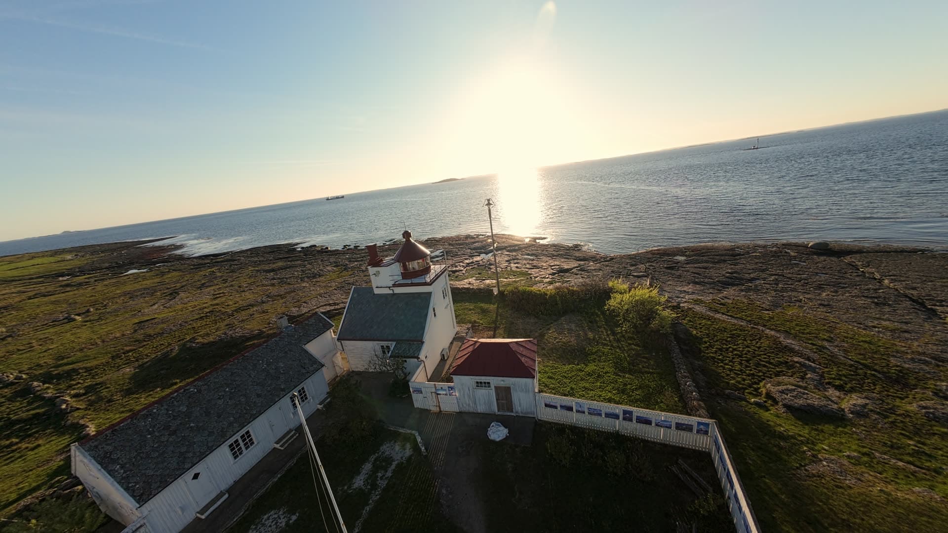 Lighthouse on rocky coastal headland, Tungenes fyr