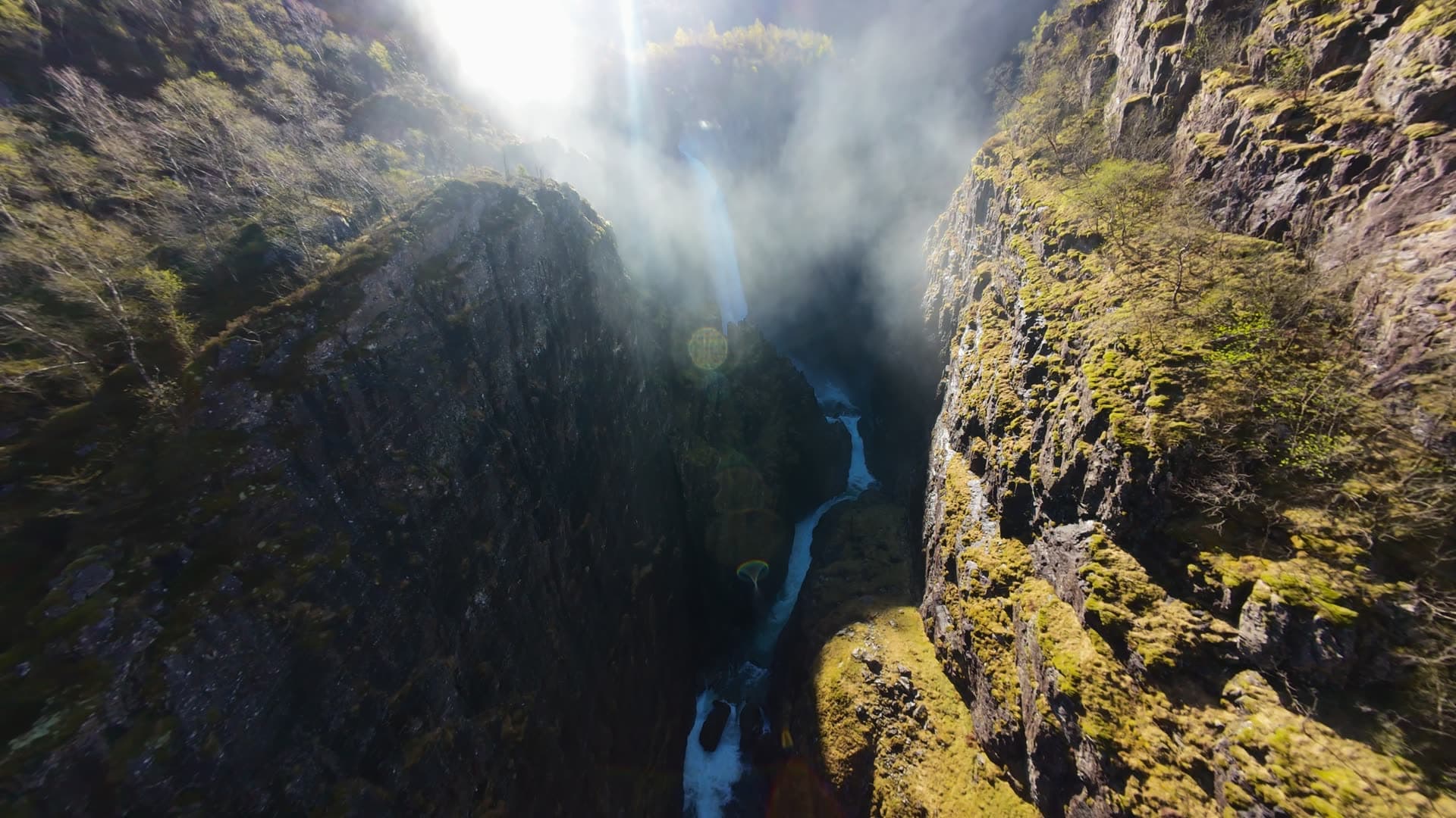 Waterfall flowing through deep rocky gorge, Månafossen