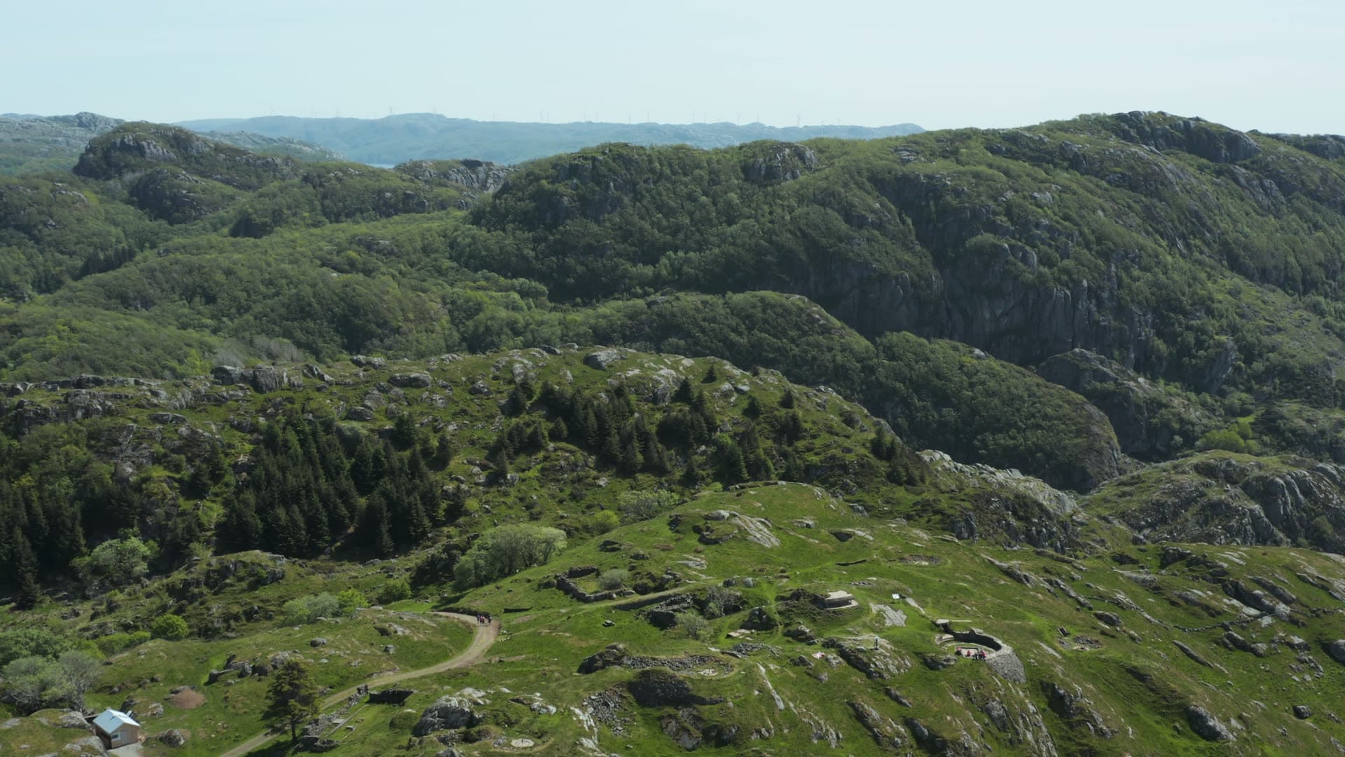 Green hillside valley with scattered farms, Hågåsen kystbatteri