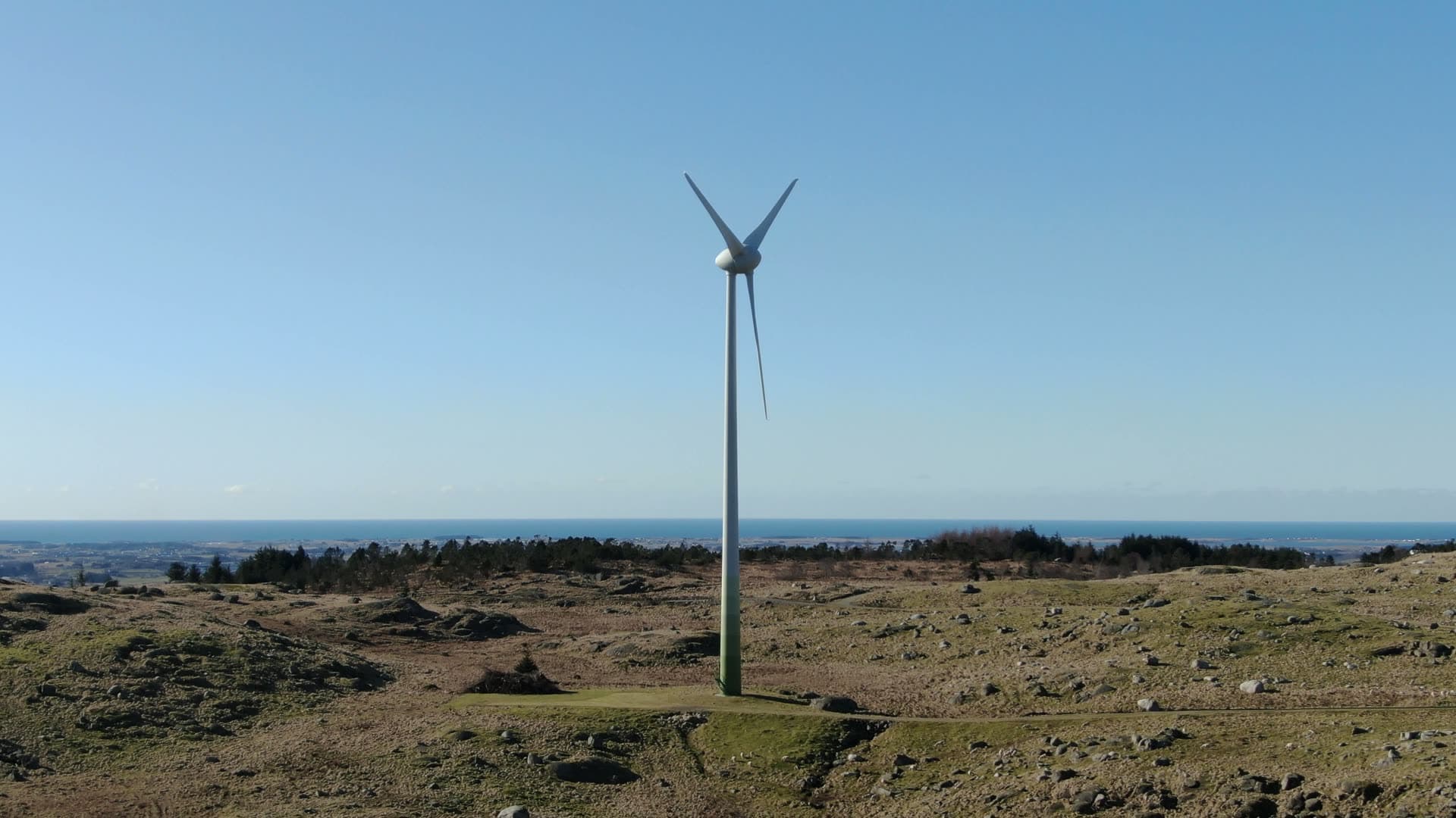 Small wind turbine rotating on moorland, Rogaland