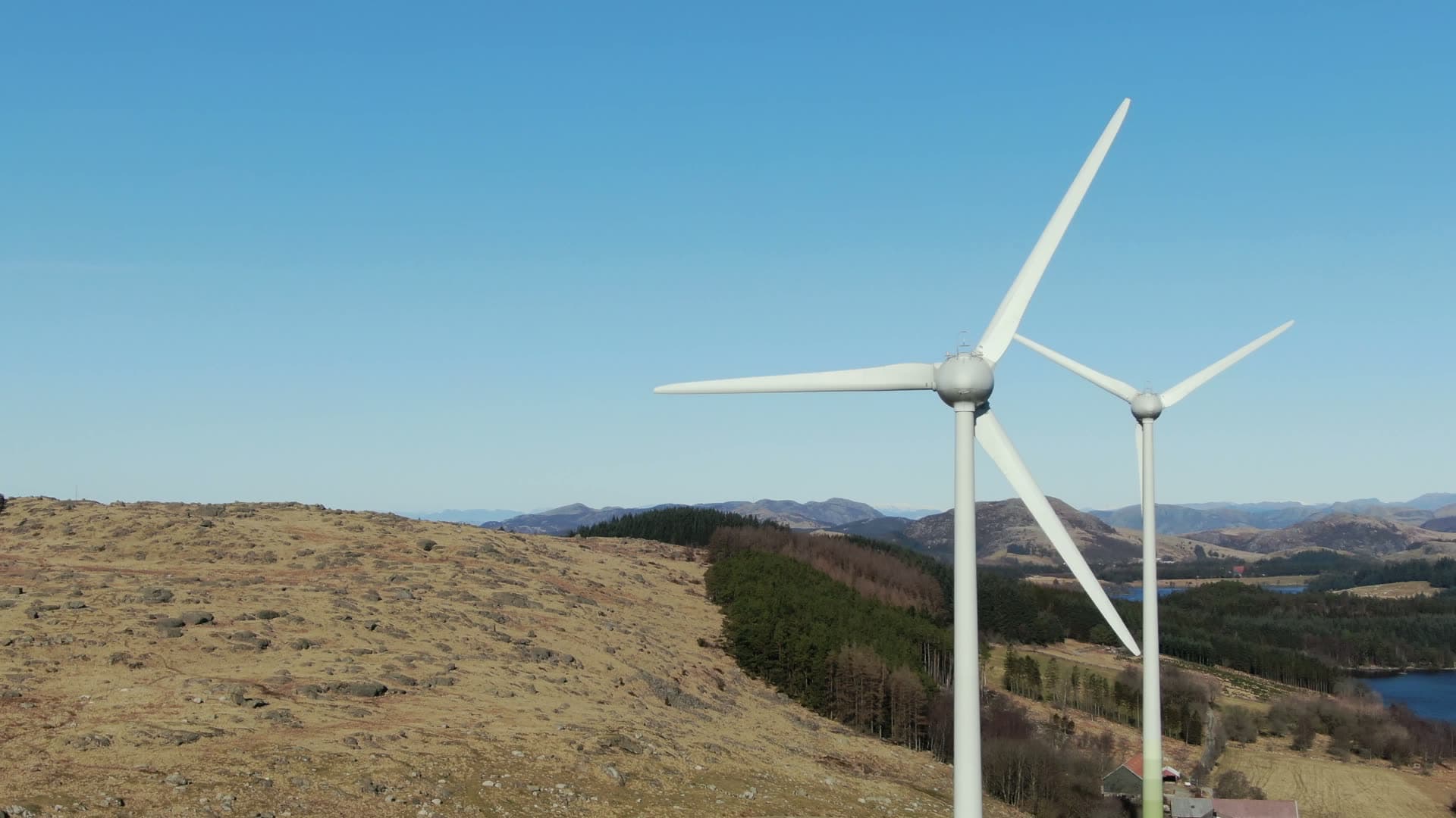 Wind turbines on hillside with lake, Rogaland