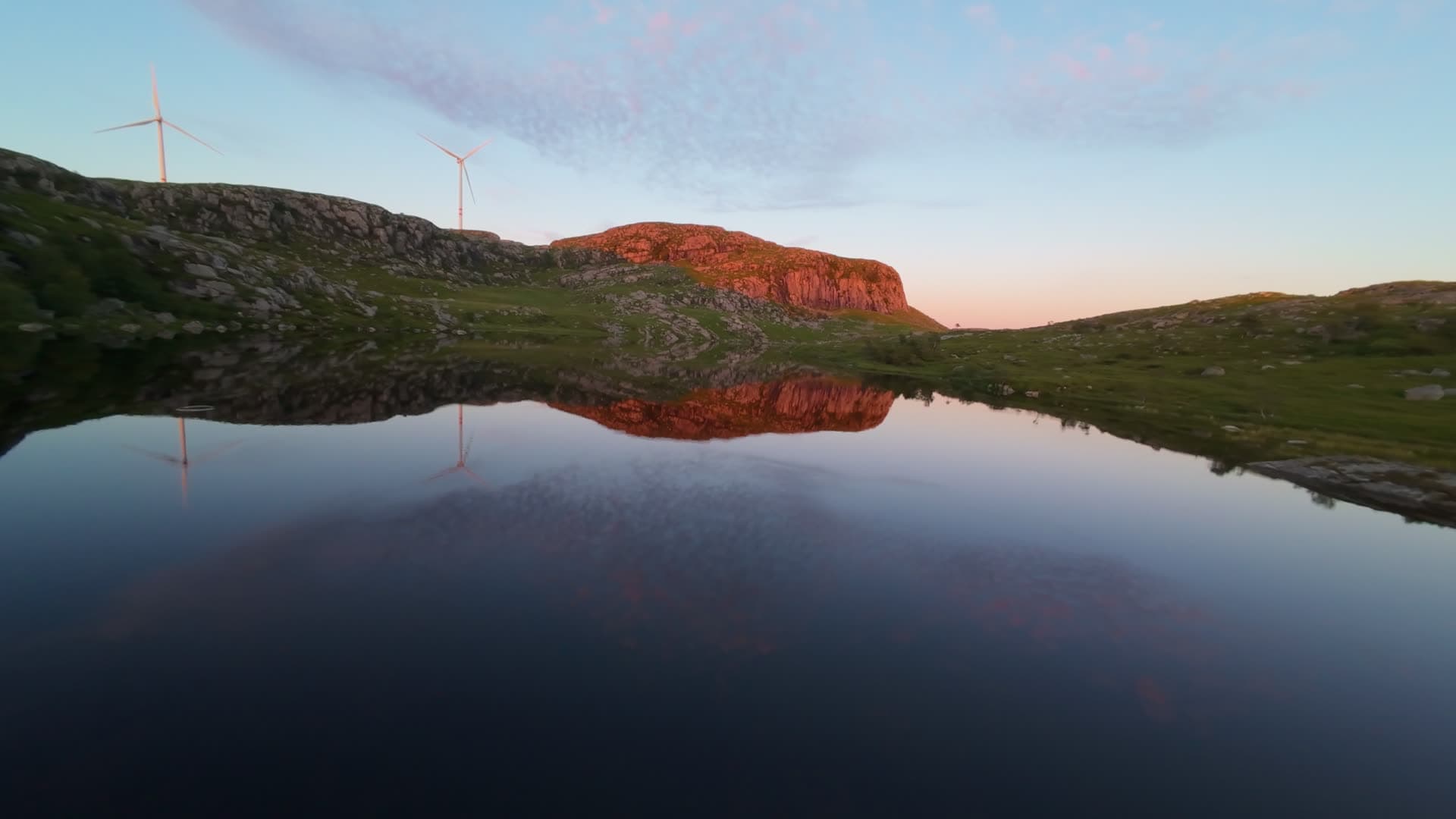 Mountain lake reflecting red cliff at sunset, Sulken
