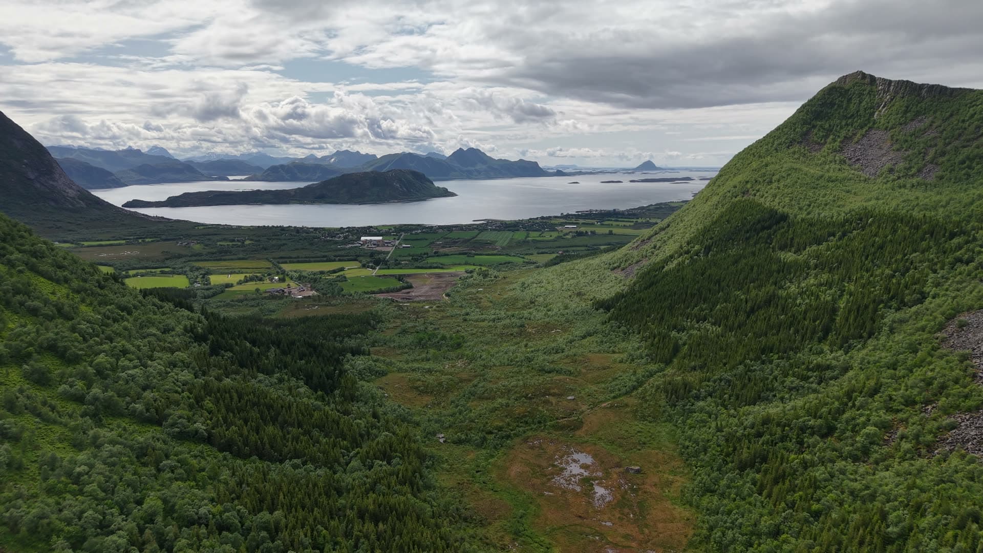 Mountain valley opening to fjord landscape, Meløy