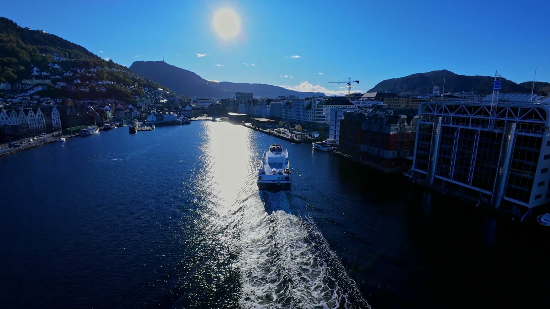 Cruise ship departing harbor with wake trail, Bryggen