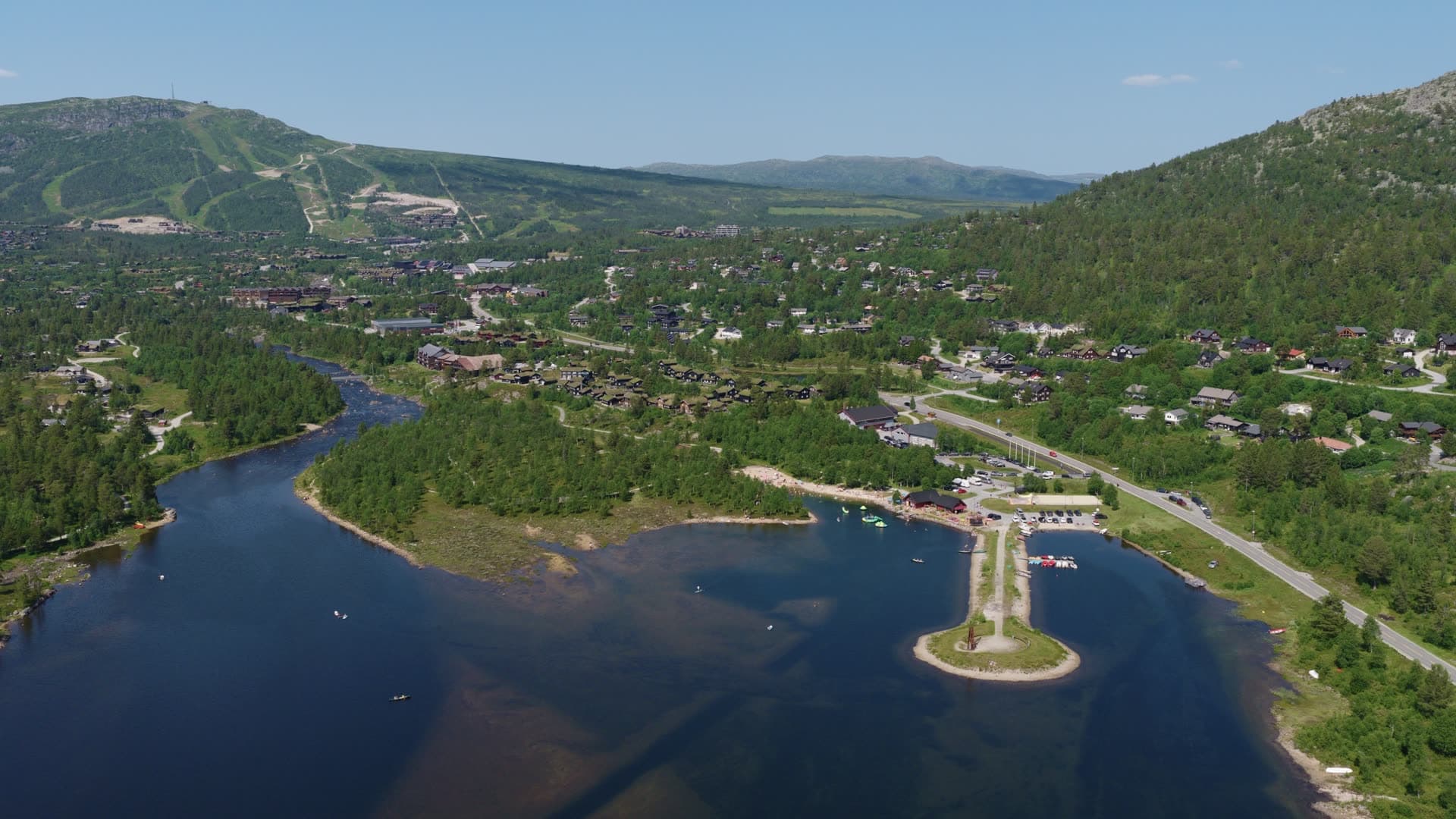 Lakeside valley with forested slopes and boating, Hovden