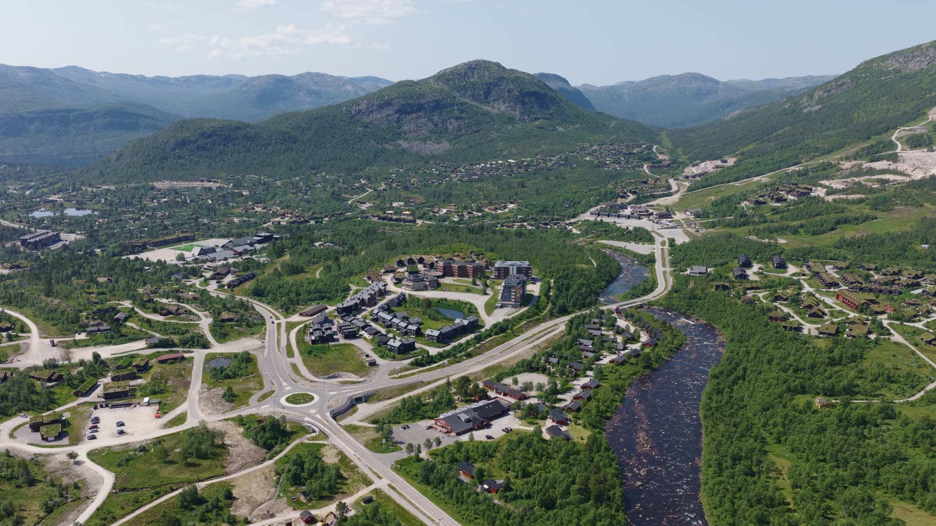 Modern valley community with river and mountain slopes, Hovden