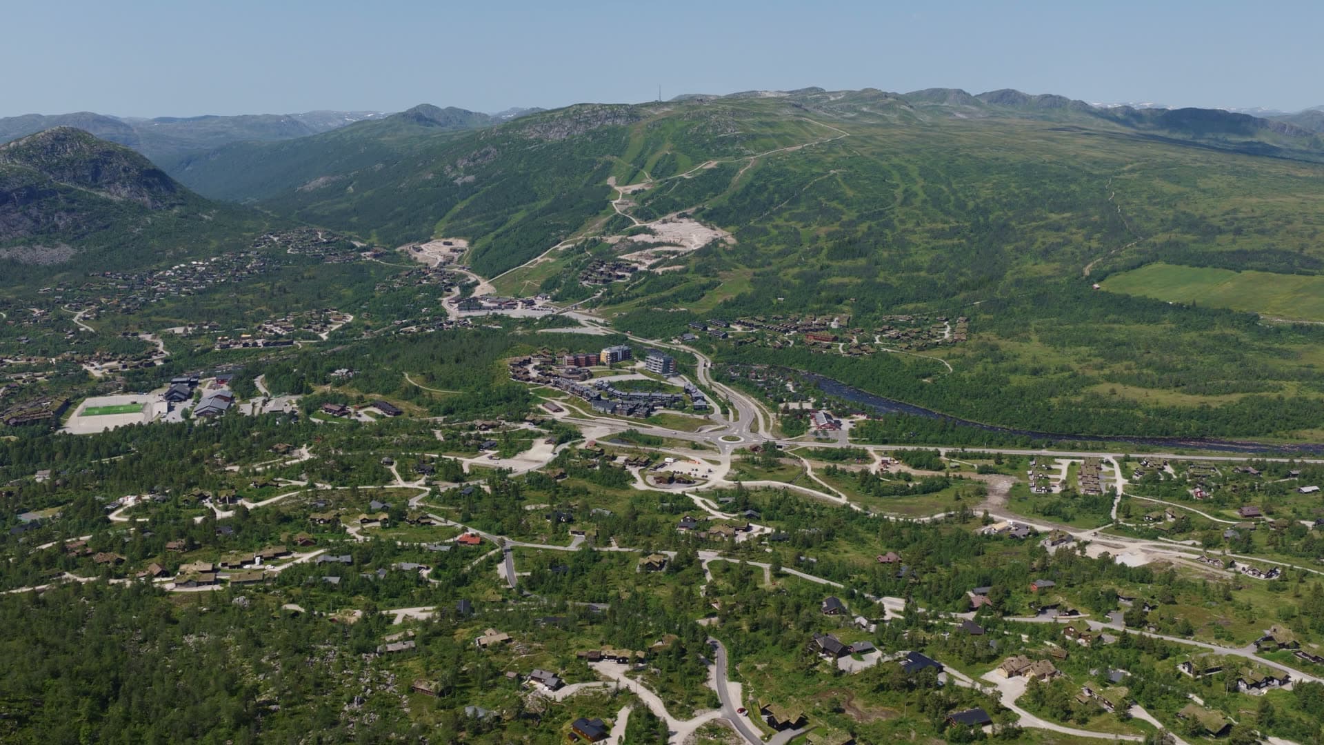 Mountain valley residential area with winding roads, Hovden