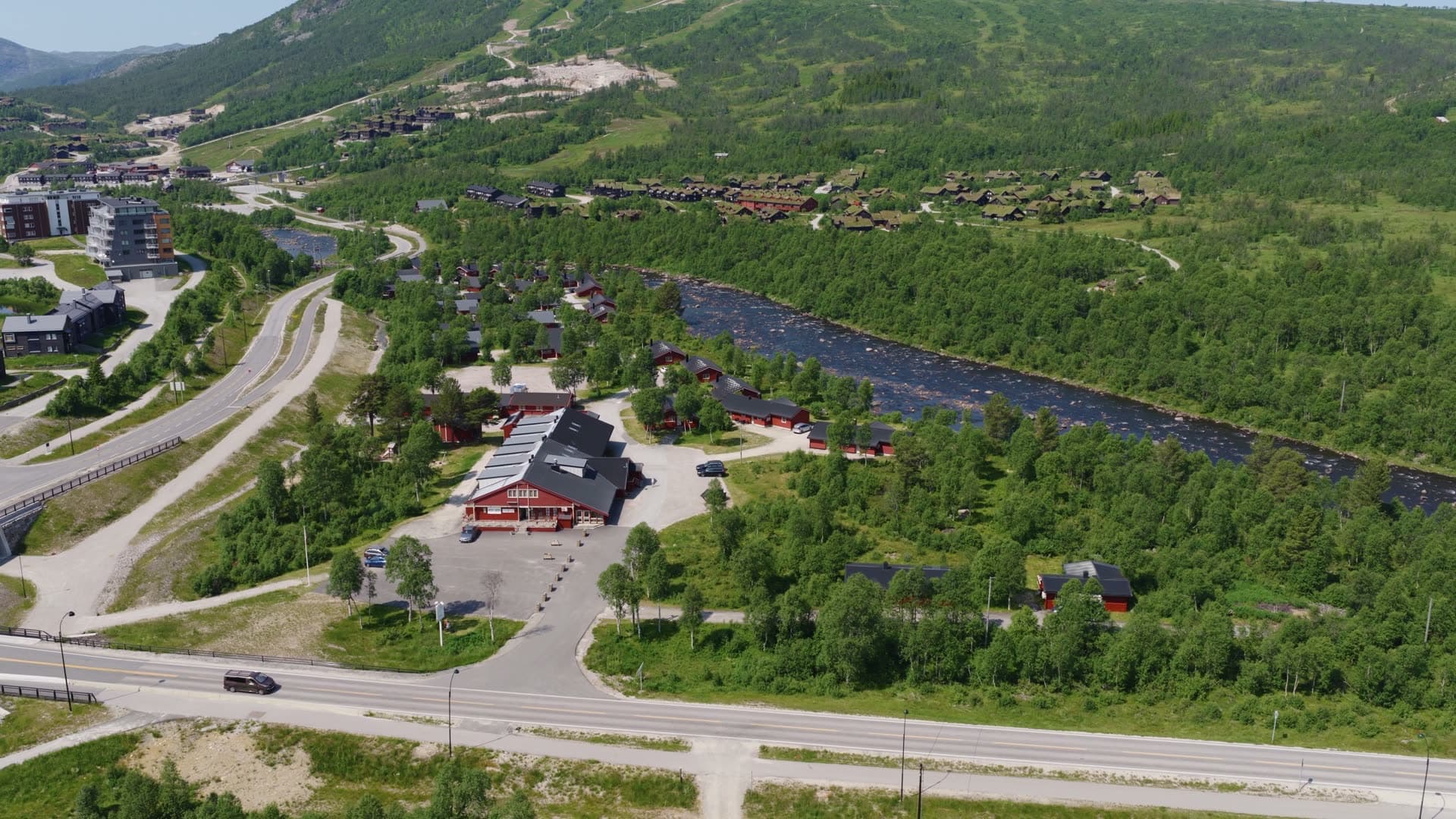 Red visitor center in mountain river valley, Hovden