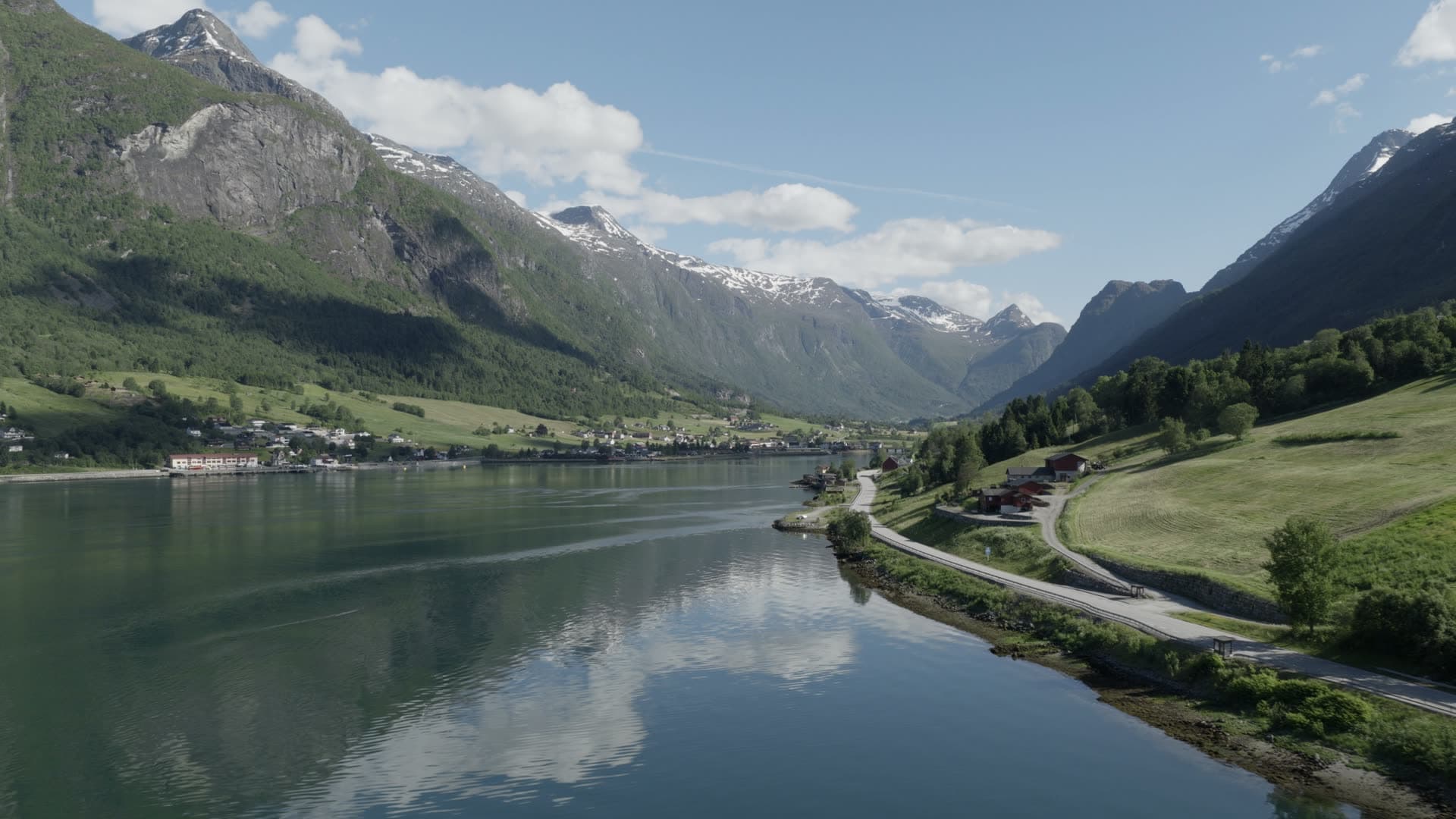 Alpine lake valley with snow-capped peaks, Olden