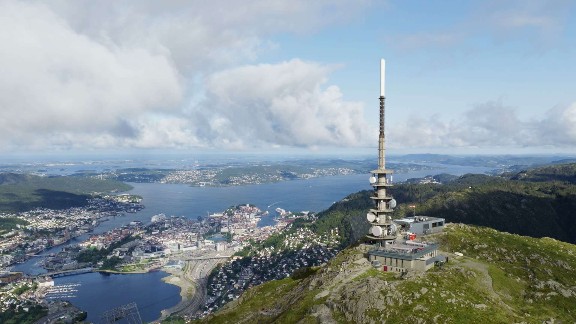 Mountain broadcast tower overlooking lake and city, Alrekstad